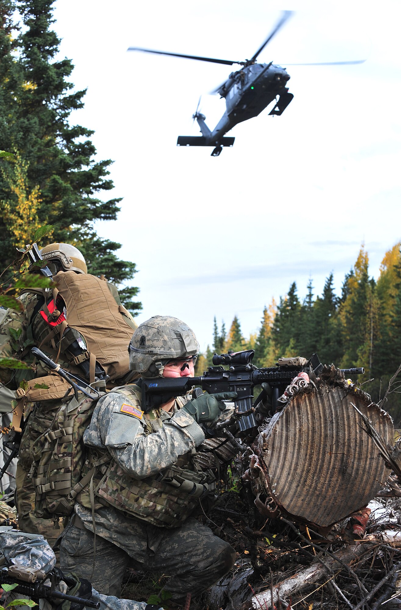 Spc. Michael Hillhouse, Baker Company, 3rd Battalion (Airborne), 509th Infantry Regiment, radio telephone operator, provides security as an HH-60G Pavehawk helicopter lands to evacuate casualties during a training exercise at Joint Base Elmendorf-Richardson on September 21, 2011.  The training focused on quick-care-under-fire and also gave training to Baker Company on how to react when pararescuemen arrive.  (U.S. Air Force photo/Staff Sgt. Zachary Wolf) 