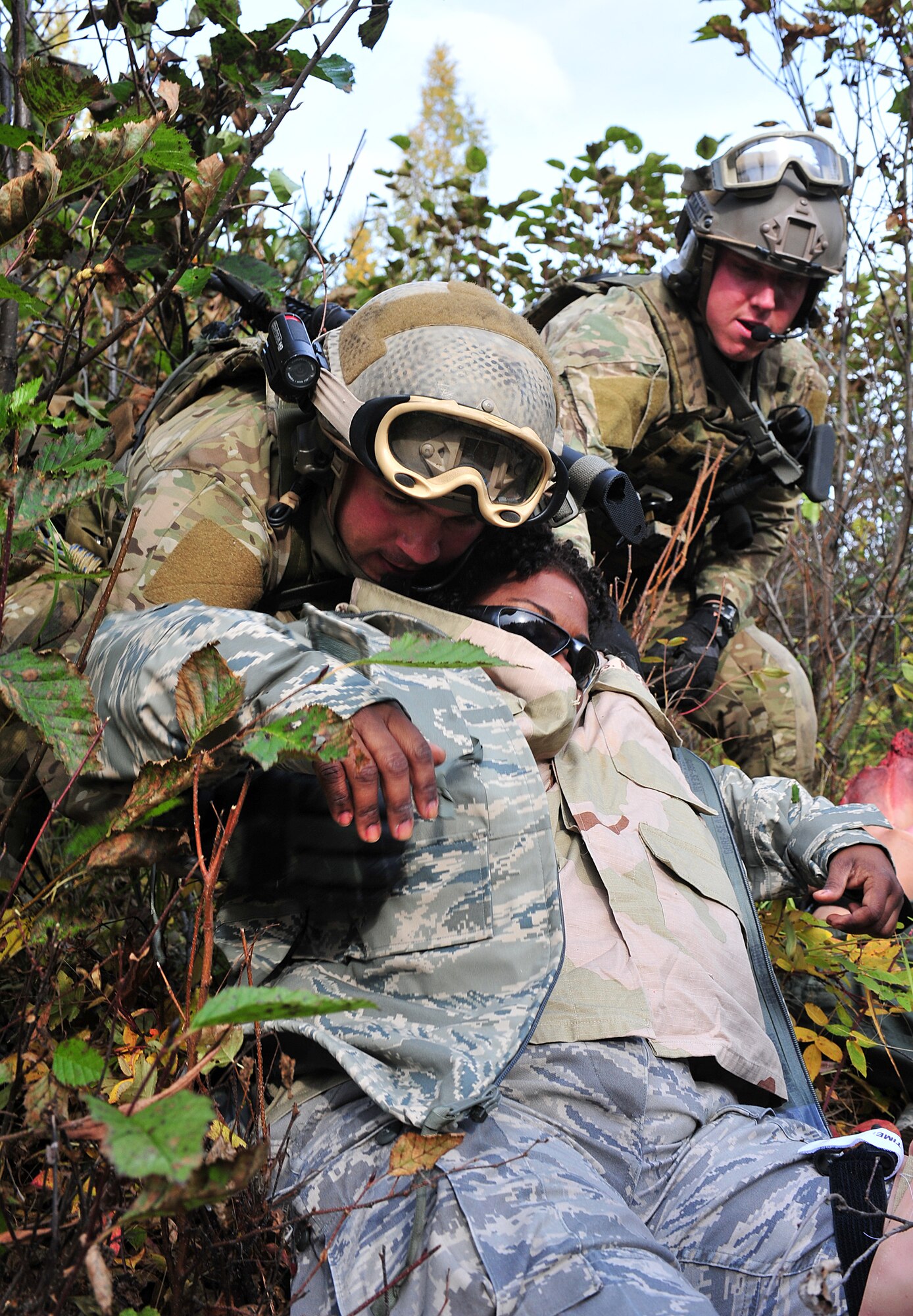 Tech. Sgt. Jeremy Maddamma (left) and Staff Sgt. BIll Cenna(right), 212th Rescue Squadron pararescuemen, drag a patient while under simulated fire during training at Joint Base Elmendorf-Richardson on September 21, 2011.  The training focused on quick-care-under-fire and also gave training to Baker Company, 3rd Battalion (Airborne), 509th Infantry Regiment, on how to react when pararescuemen arrive.  (U.S. Air Force photo/Staff Sgt. Zachary Wolf) 