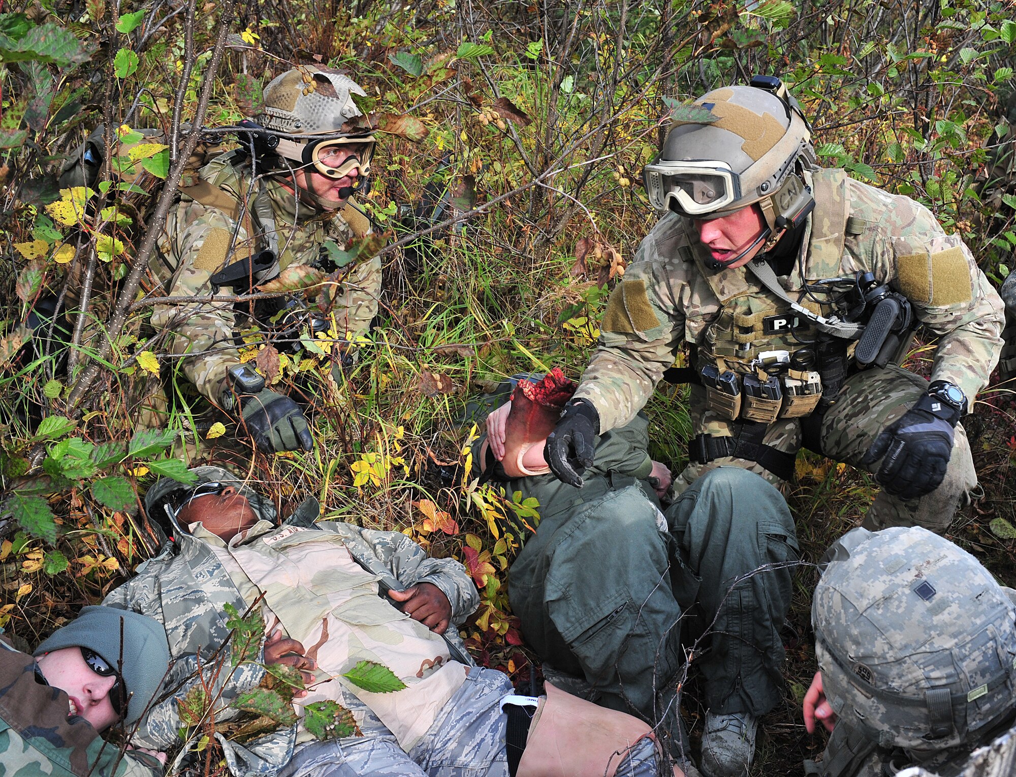 Tech. Sgt. Jeremy Maddamma (left) and Staff Sgt. BIll Cenna(right), 212th Rescue Squadron pararescuemen, treat patients during training at Joint Base Elmendorf-Richardson on September 21, 2011.  The training focused on quick-care-under-fire and also gave training to Baker Company, 3rd Battalion (Airborne), 509th Infantry Regiment, on how to react when pararescuemen arrive.  (U.S. Air Force photo/Staff Sgt. Zachary Wolf) 