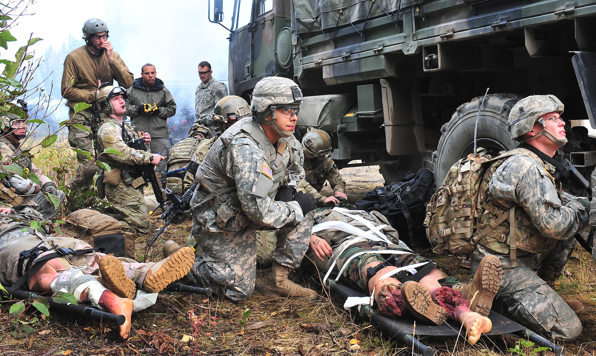 Pararescuemen from the 212th Rescue Squadron  and members of Baker Company, 3rd Battalion (Airborne), 509th Infantry Regiment,look for the HH-60G Pavehawk helicopter during training on Joint Base Elmendorf-Richardson September 21, 2011.  The training focused on quick-care-under-fire and also gave training to Baker Company on how to react when pararescuemen arrive.  (U.S. Air Force photo/Staff Sgt. Zachary Wolf)