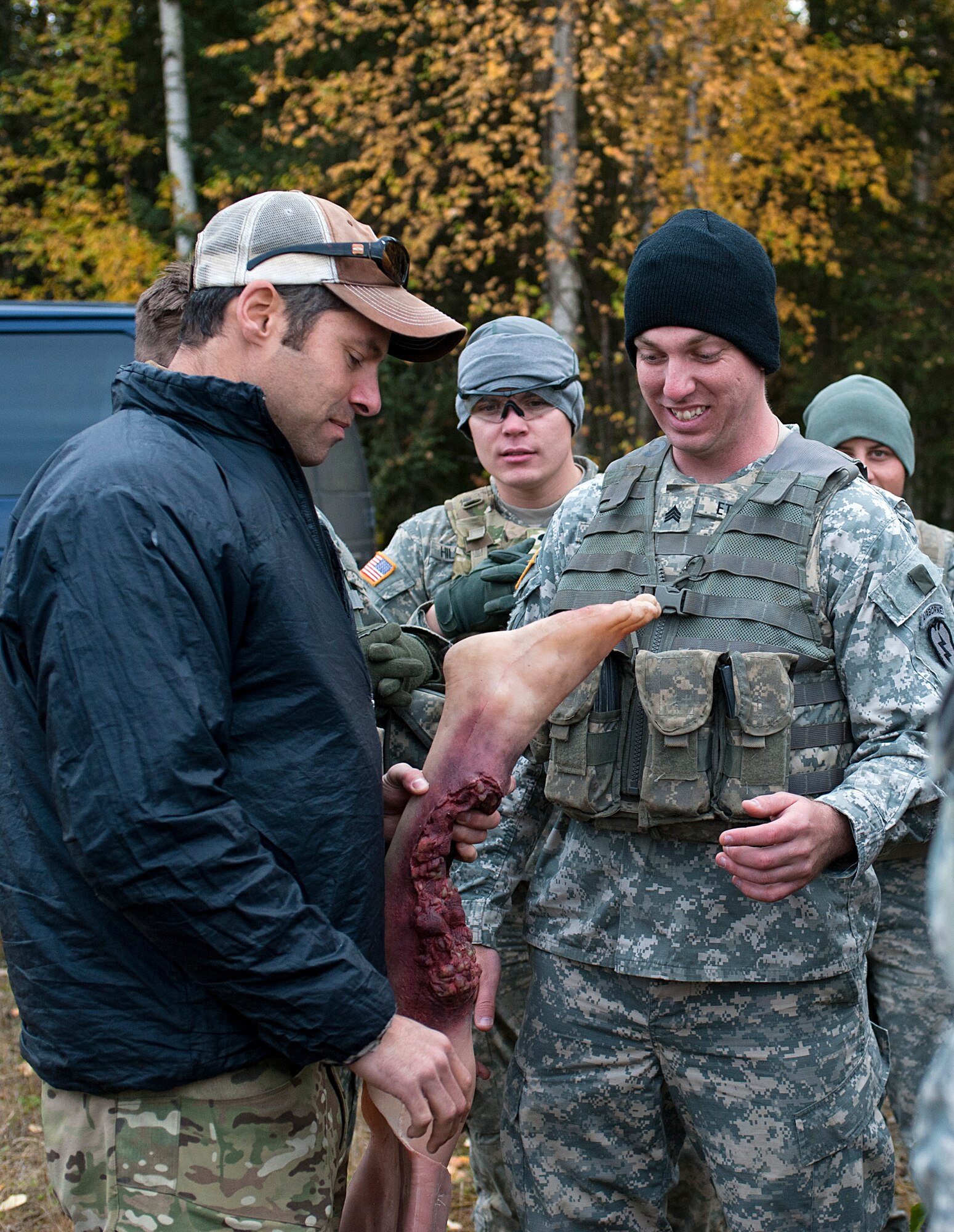 Senior Master Sgt. Jon Davis, 212th Rescue Squadron pararescueman, shows Army Sgt. Joshua Etheridge, Baker Company, 3rd Battalion (Airborne), 509th Infantry Regiment, a moulage leg for someone in his squad to attach at Joint Base Elmendorf-Richardson on September 21, 2011.  The moulage is used to help train the pararescuemen on what they might see while performing a rescue and how to respond to that injury.  (U.S. Air Force photo/Staff Sgt. Zachary Wolf)