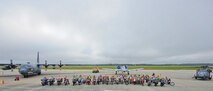 Team Moody motorcyclists pose for a group photo in front of an HC-130P Combat King, a Mine Resistant Ambush Protected vehicle, an A-10C Thunderbolt II and an HH-60G Pave Hawk at Moody Air Force Base, Ga., Sept. 23, 2011. The 23rd Safety office organized the event to promote and educate individuals on motorcycle safety. (U.S. Air Force photo by Senior Airman Stephanie Mancha/Released)