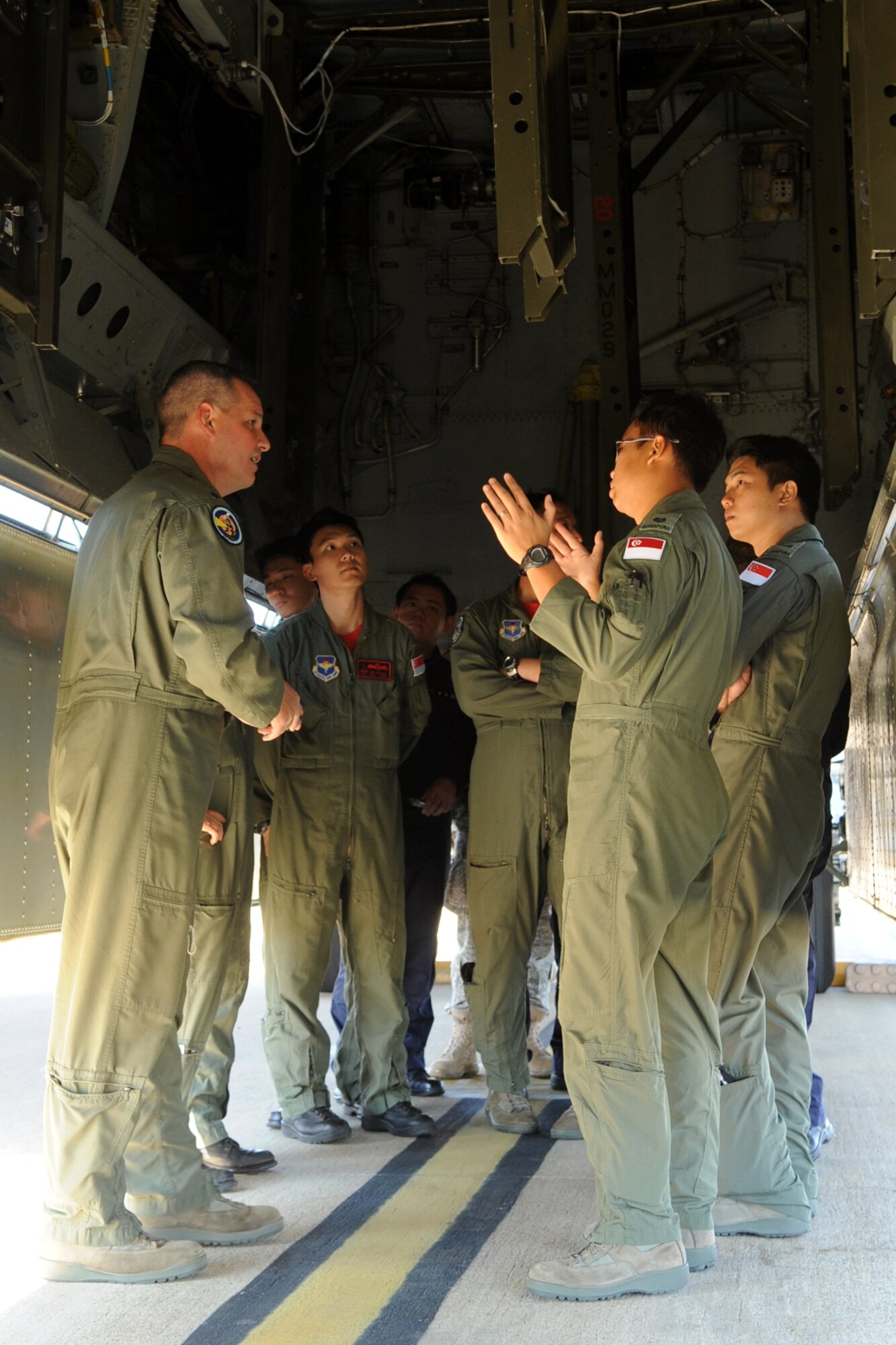 Lt. Col. Jeff Stogsdill, 548th Combat Training Squadron assistant director of operations, answers questions about the B-52 Stratofortress from members of the 425th Fighter Squadron (FS), who are on temporary duty at Barksdale Air Force Base, La., in support of a Green Flag exercise, Sept. 23, 2011. The 425th FS, assigned to Luke Air Force Base, Ariz., provides advanced weapons and tactics training for Republic of Singapore F-16 pilots and maintenance personnel. Green Flag is an exercise designed to prepare pilots for combined, air, ground and electronic threat environments. (U.S. Air Force photo by Master Sgt. Greg Steele/Released)