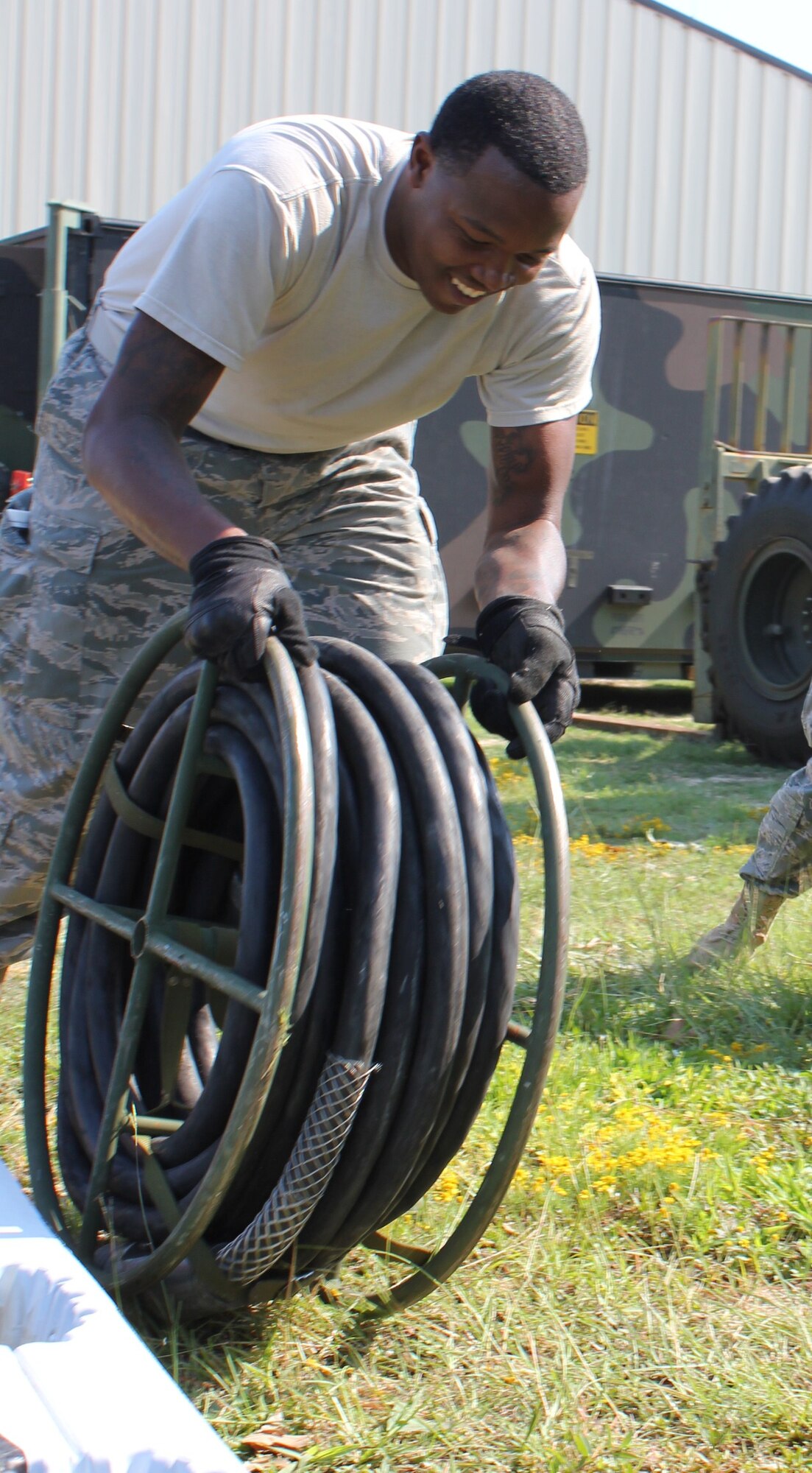 Senior Airman Jevon Counts, 21st Air Mobility Operations Squadron, rolls
50 feet cable during the set up of Deployable Air Mobility Divisions Communications Elements and joker charlie shelter in support of the 2011 Joint Operations Access Exercise Sept. 8 through 13 at Pope Army Airfield, N.C. The 621st Contingency Response Wing's main mission is to provide versatile mobility Airmen to execute theater operational command and control in support of the global mobility mission. (U.S. Air Force photo by Staff Sgt Francis Lalic/Released)
