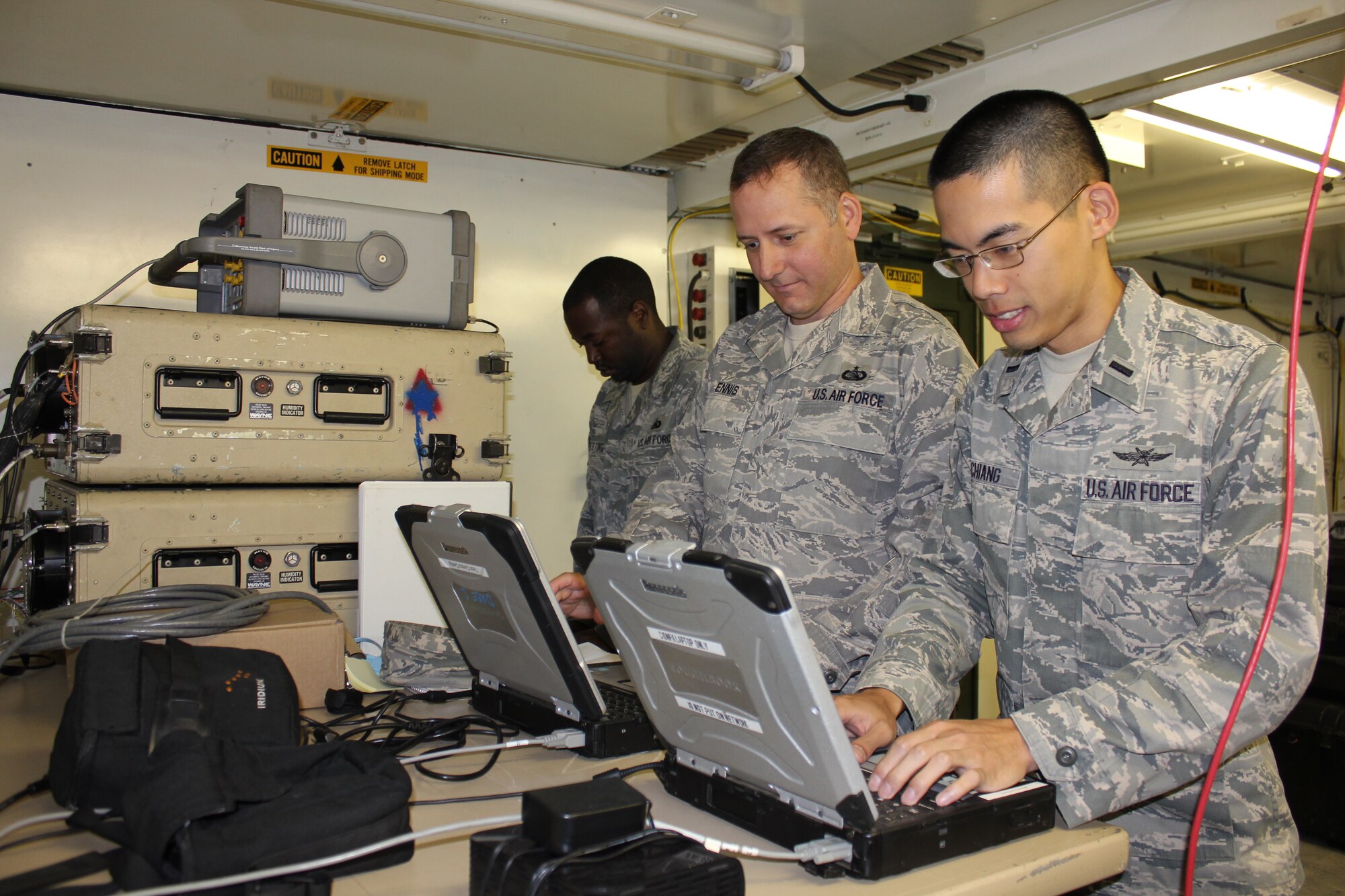 (Right to left) 1st Lt. Johnny Chiang, Tech. Sgt. Gary Ennis, both from the 21st Air Mobility Operations Squadron, and Tech. Sgt. Irvin Sweeting, 15th AMOS, configure the Deployable Air Mobility Divisions Communications Elements communications equipment during the 2011 Joint Operations Access Exercise Sept. 8 through 13 at Pope Army Airfield, N.C. Members from 21st Air Mobility Operations Squadron provided 24-hour command and control, logistics, civil engineering and communication support for the exercise. JOAX is a joint military services training exercise conducted to test U.S. Army's 82d Airborne Division's ability to jump into a hostile environment and U.S. Air Force's 621st Contingency Response Wing to conduct combat operations, along with Company M, 3rd Royal Canadian Regiment. (U.S. Air Force photo by Staff Sgt Francis Lalic/Released)