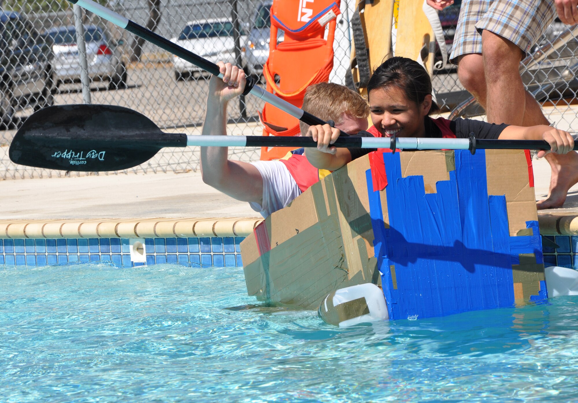 SAN ANGELO, Texas -- Airman 1st Class Tearra Ramez, 17th Medical Group, tries to keep the makeshift boat from capsizing as her teammate Airman 1st Class Patrick Eichamer, 17th MDG, gets in during the Build a Boat contest at the Recreation Camp Sept. 24. (U.S. Air Force photo/Connie Hempel)