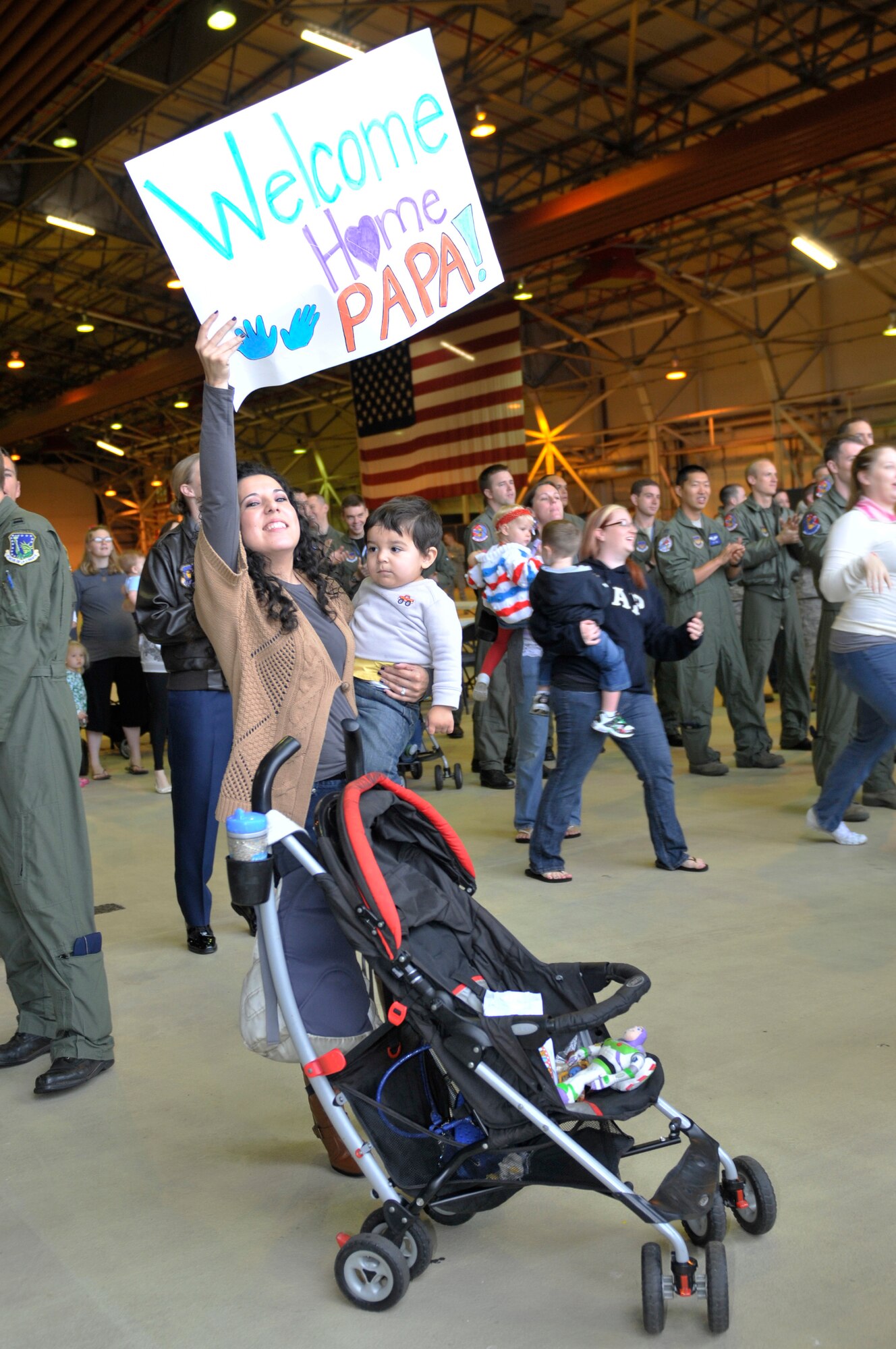 ROYAL AIR FORCE LAKENHEATH, England ? Violet, wife of Staff Sgt. Fernando Solis, 48th Aircraft Maintenance Squadron avionics specialist, and 2-year-old son Roman, wait to greet Solis on Sept. 26, 2011.  Airmen from the 494th Fighter Squadron and other 48th FW personnel returned from deployment to Kunsan Air Base, South Korea where they supported the 8th FW?s mission. (U.S. Air Force photo by Senior Airman Lausanne Morgan)