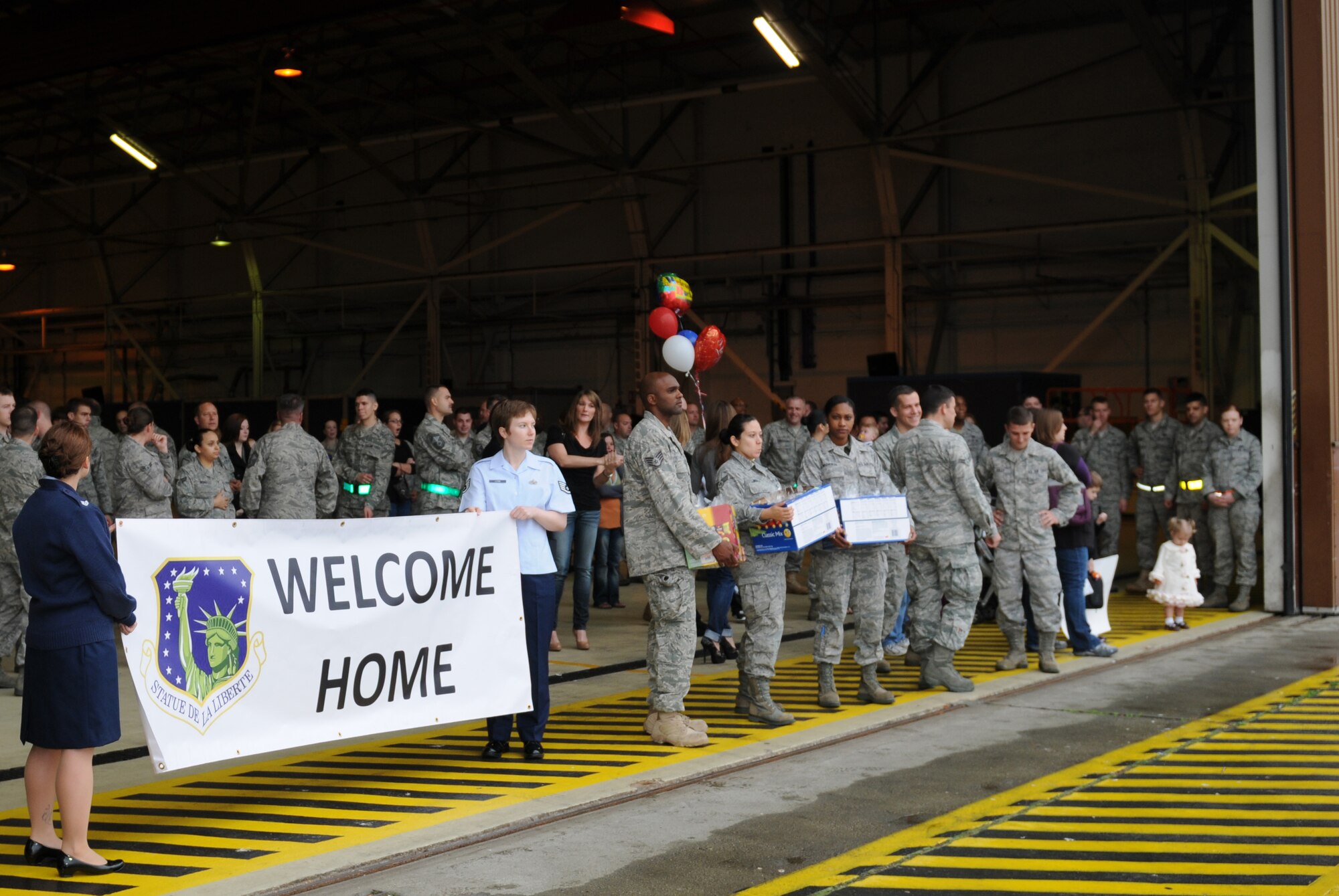 ROYAL AIR FORCE LAKENHEATH, England - Members of the 48th Fighter Wing and families eagerly await the arrival of deployment returnees at Hangar 7 on Sept. 26, 2011. Airmen from the 494th Fighter Squadron and other 48th FW personnel returned from deployment to Kunsan Air Base, South Korea where they supported the 8th FW's mission. (U.S. Air Force photo/Airman Cory D. Payne)