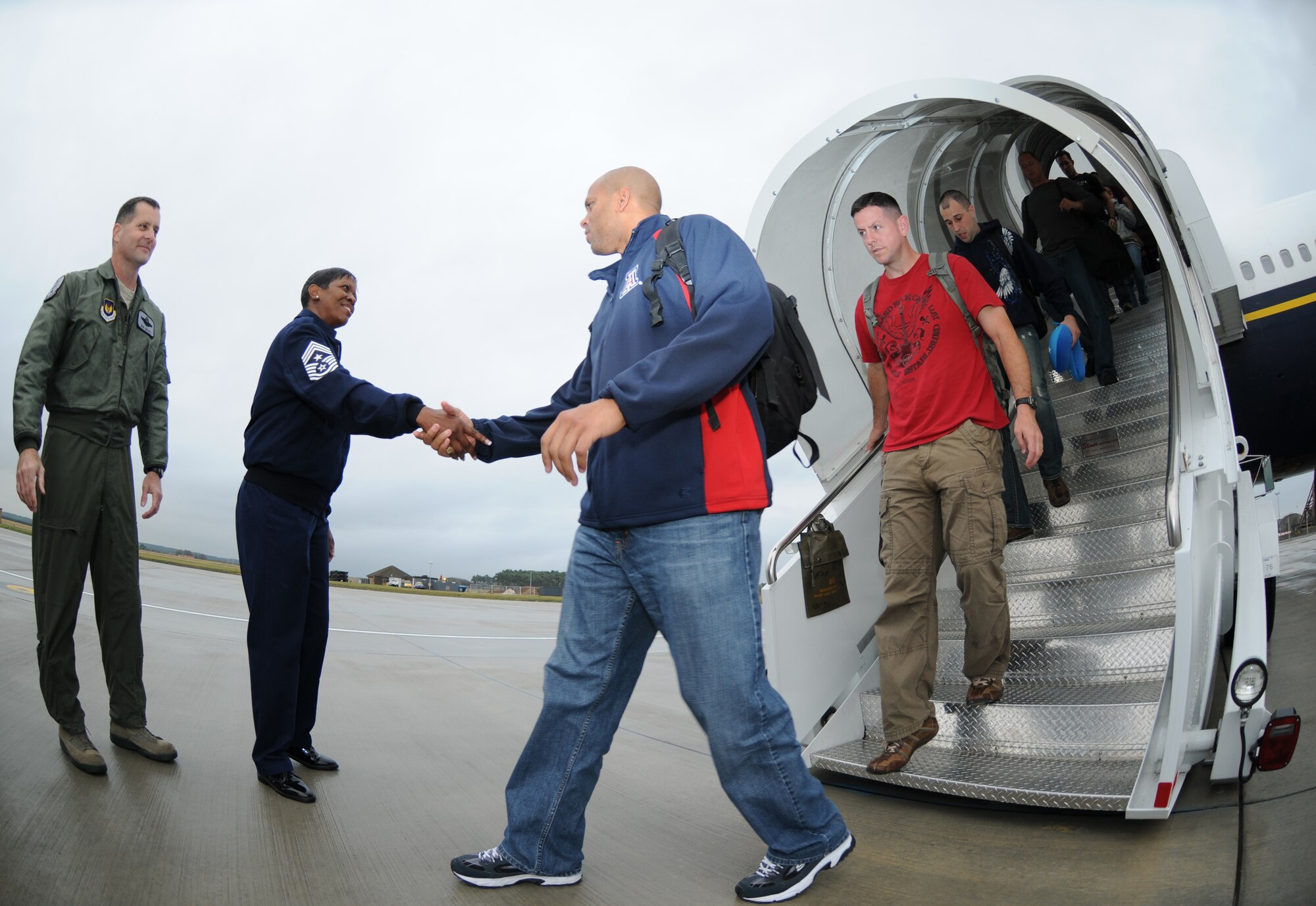 ROYAL AIR FORCE LAKENHEATH, England  Members of the 48th Fighter Wing are greeted by Chief Master. Sgt. SaRita Lathan, 48th FW command chief, and other base leadership as they depart the aircraft on Sept. 26, 2011. Airmen from the 494th Fighter Squadron and other 48th FW personnel returned from deployment to Kunsan Air Base, South Korea where they supported the 8th FW's mission. (U.S. Air Force photo/Airman Cory D. Payne)