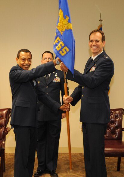 MacDill Air Force Base, Fla. --   Colonel Rodney Bryan, commander of the 927th Mission Support Group, passes the guidon of the 927th Force Support Squadron to Lt. Col. Bruce Winhold during a change of command ceremony here.  Winhold assumed command of the squadron with his wife, parents, and unit members present.  (Official U.S. Air Force photo by Staff Sgt. Shawn Rhodes)