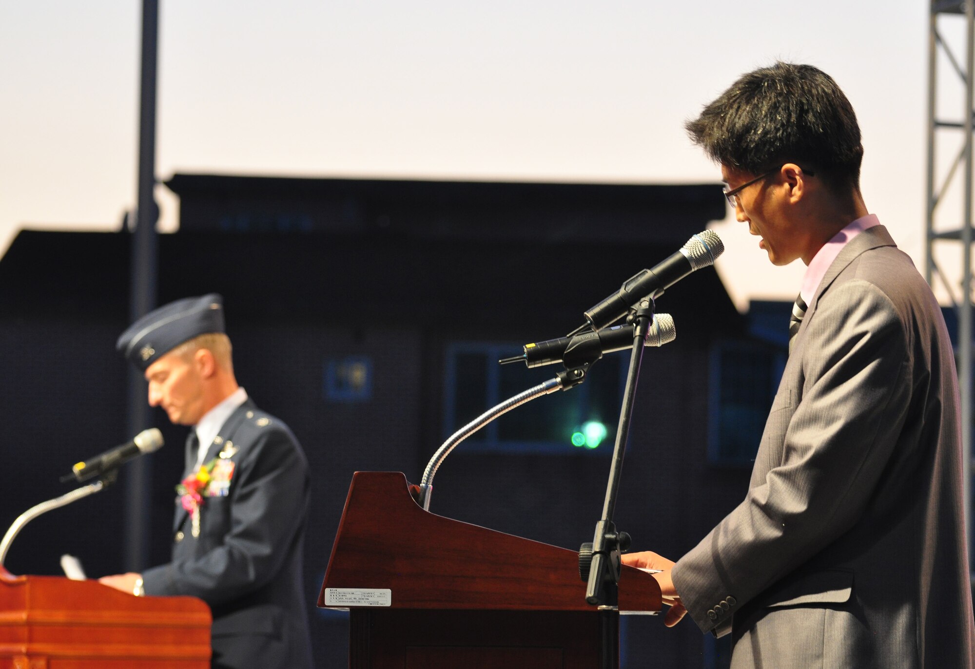 Mr. Pak, Yonghui (right), 51st Fighter Wing Public Affairs, translates for Col. Patrick McKenzie (left), 51st Fighter Wing Commander, during opening remarks Sept. 24, 2011, at the eighth annual Korean American Friendship Cultural Festival. The festival was sponsored by the Songtan Chamber of Commerce and celebrates the great friendship between Koreans and Americans. (U.S. Air Force photo/Tech. Sgt. Chad Thompson)