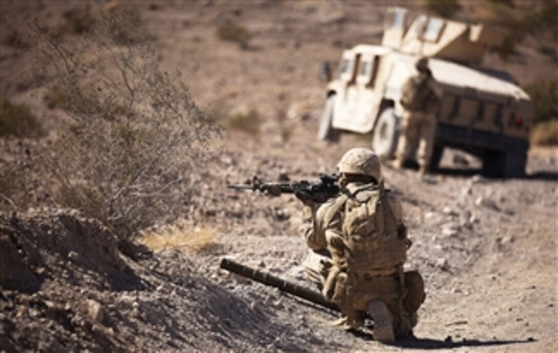 U.S. Marine Corps Lance Cpl. Justin Downing scans his area while on patrol during Exercise Clear, Hold, Build 3 at Marine Corps Air Ground Combat Center Twentynine Palms, Calif., on Sept. 21, 2011.   Downing is a mortar man with 3rd Battalion, 3rd Marine Regiment.  The battalion is taking part in the Enhanced Mojave Viper training exercise, which is the final pre-deployment training event before deploying to Afghanistan Helmand province to support Operation Enduring Freedom.   