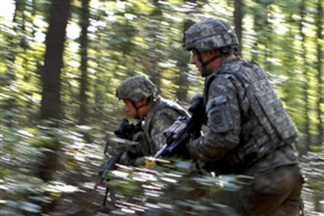 Paratroopers charge through the woods during a frontal attack on an insurgent position during a mountain training exercise on Camp Frank D. Merrill near Dahlonega, Ga., Sept. 21, 2011. The paratroopers are assigned to the 82nd Airborne Division’s Company A, 1st Battalion, 504th Parachute Infantry Regiment. The training teaches mountaineering skills and prepares soldiers for deployment to a mountainous region such as Afghanistan.