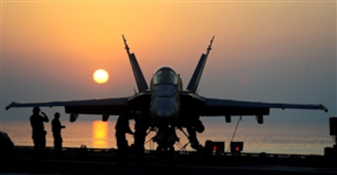 Sailors prepare an F/A-18C Hornet for flight operations aboard the aircraft carrier USS John C. Stennis (CVN 74) as the ship operates in the 5th Fleet area of responsibility on Sept. 20, 2011.  The Stennis is conducting maritime security operations and support missions as part of Operations Enduring Freedom and New Dawn.  The Hornet is attached to Strike Fighter Squadron 192.  