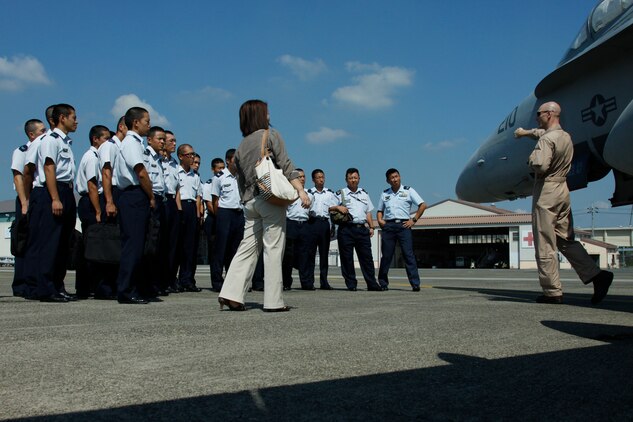 Capt. Anthony D. Ramey, Marine Aircraft Group 12 current operations officer, explains to Japan Air Self-Defense Force cadets the importance of pre-checks before a flight during a Japanese Observer Exchange Program tour here Sept. 27. The tour refocused the cadets’ efforts to complete flight training.