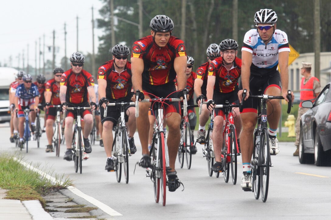 Frankie Andreu (white), 1998 to 2000 team captain of the U.S. Postal Service cycling team, leads a group of wounded warriors on a three-mile cycling ride during the Wounded Warrior cycling camp held aboard Camp Geiger, Sept. 27 through 29. The camp helped the Marines’ recovery process by using their injuries to their advantage, utilizing the cycles to improve their overall health.