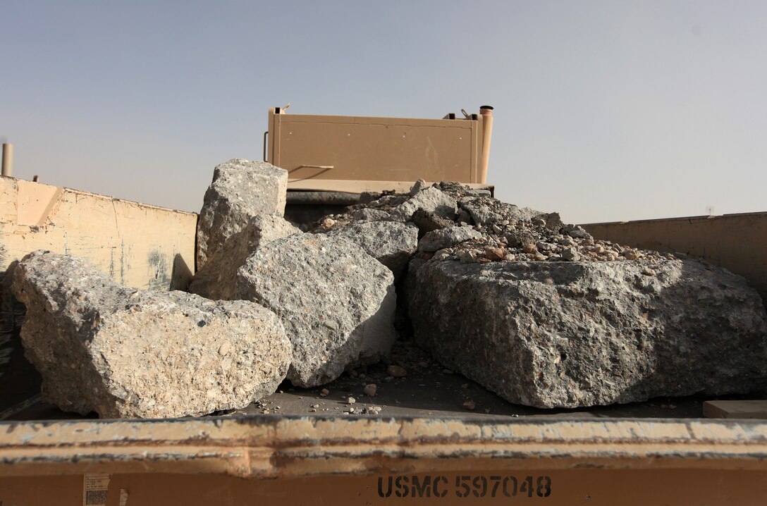 For the past three weeks, Marines from 7th Engineer Support Battalion have hauled several metric tons of broken concrete and stone to banks of the Helmand River near Forward Operating Base Sabit Qadam, Afghanistan. The debris serves at the foundation of a causeway, which will provide a platform for a forthcoming bridge project. (U.S. Marine Corps photo by Sgt. Justin J. Shemanski)