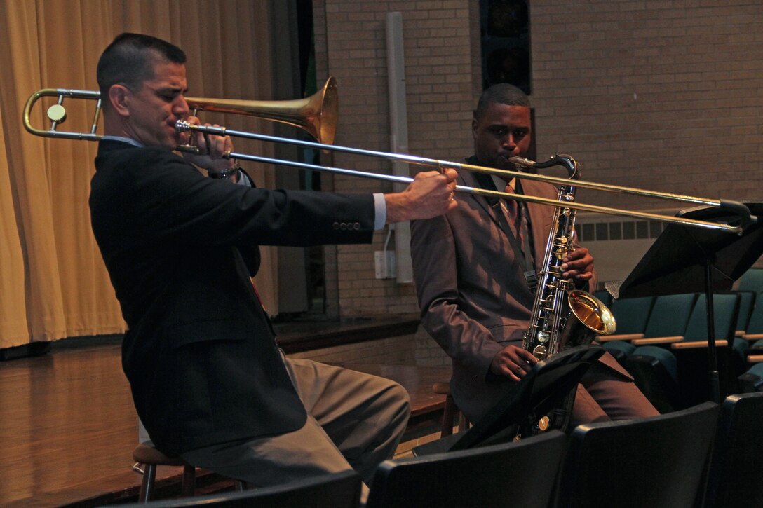 Staff Sgt. Ken Ebo, a trombone instructor at the School of Music, and Gunnery Sgt. Jason Knuckles, 9th Marine Corps District Marine band placement director, show off their jazz skills for upperclassmen at Coon Rapids High School Sept. 27. This was one of several stops the group made while traveling across Minnesota and Western Wisconsin to promote the Marine Corps Musician Enlistment Option Program. For additional imagery from their tour, visit www.facebook.com/rstwincities.