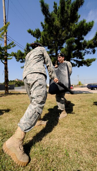 Members of the 8th Security Forces Squadron practice striking with the expandable baton on one another at Kunsan Air Base, Republic of Korea, Sept. 26, 2011. Expandable batons are specifically used to deescalate a situation with the least amount of force necessary. The expandable batons are one of the tools used by Airmen as a non-lethal means to defend themselves. (U.S. Air Force photo by Staff Sgt. Rasheen Douglas/Released)