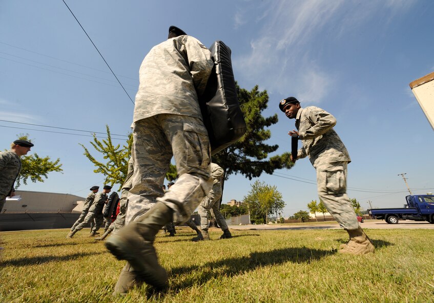 Airman 1st Class Kenneth Pyles, 8th Security Forces Squadron response force leader, gets into a defensive stance during the hands-on portion of the expandable baton training class at Kunsan Air Base, Republic of Korea, Sept. 26, 2011. Expandable batons are specifically used to deescalate a situation with the least amount of force necessary. The expandable batons are one of the tools used by Airmen as a non-lethal means to defend themselves. (U.S. Air Force photo by Staff Sgt. Rasheen Douglas/Released)