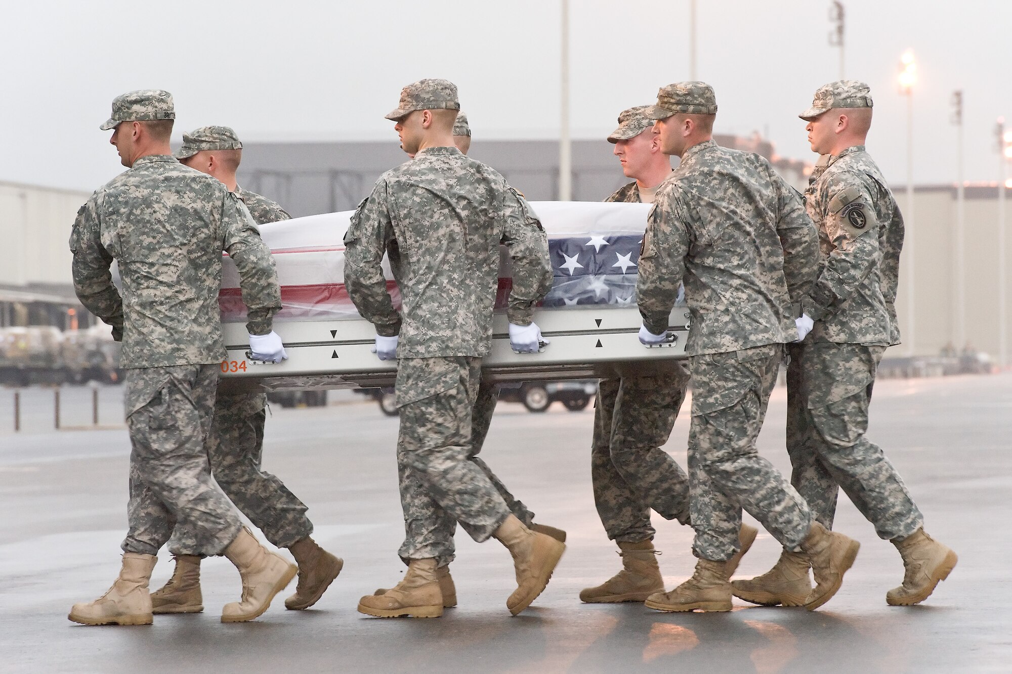 A U.S. Army carry team transfers the remains of Army Spc. Garrett A. Fant, of American Canyon, Calif., at Dover Air Force Base, Del., Sept. 27, 2011. Fant was assigned to the 4th Squadron, 4th Cavalry Regiment, 1st Heavy Brigade Combat Team, 1st Infantry Division, Fort Riley, Kan. (U.S. Air Force photo/Roland Balik)
