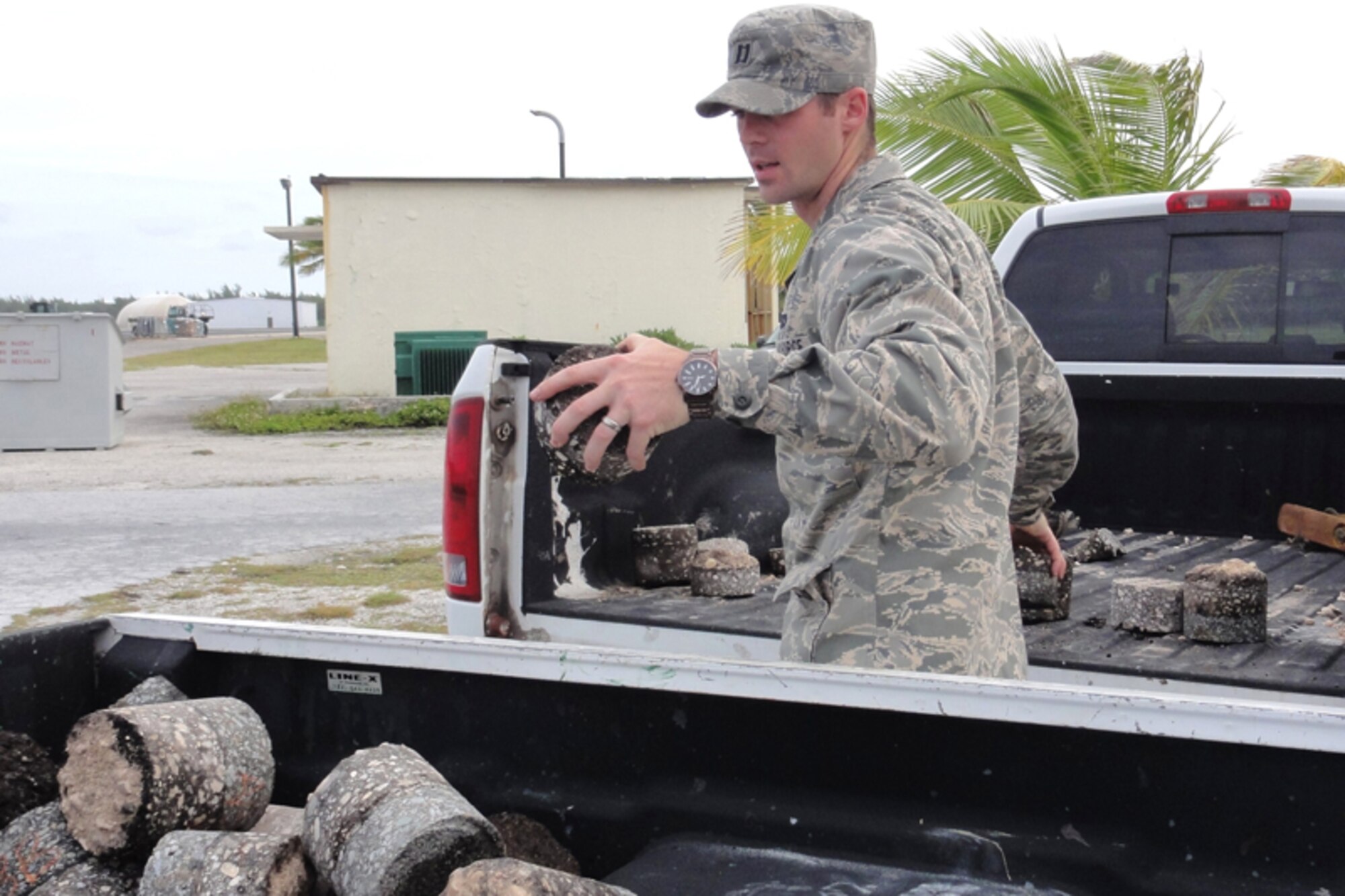 Capt. Vincent Bongioanni, AFCE SA Airfield Pavement Evaluation team chief, moves core samples from one vehicle to another.  Commissioned APE personnel are currently required to have an advanced degree in the area of pavement engineering.  (U.S. Air Force photo/Capt Amy Hansen)