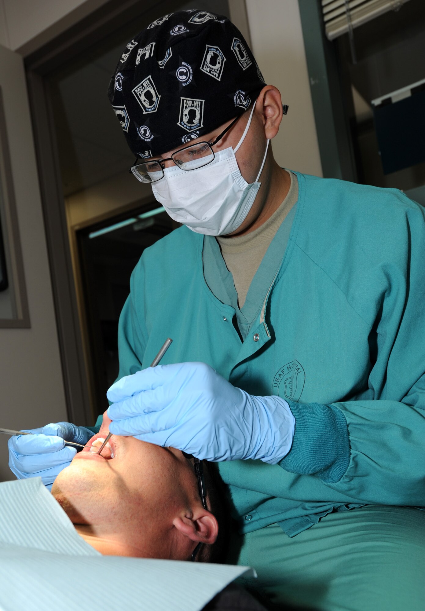 Senior Airman Gabriel Villalobos, 22nd Aerospace Medicine Squadron Dental Flight oral preventative assistant, cleans a patient’s teeth at the dental clinic Sept. 27, 2011, McConnell Air Force Base, Kan. Villalobos provides teeth cleanings as well as teaches patients about oral hygiene. (U.S. Air Force photo by Airman 1st Class Laura L. Valentine)