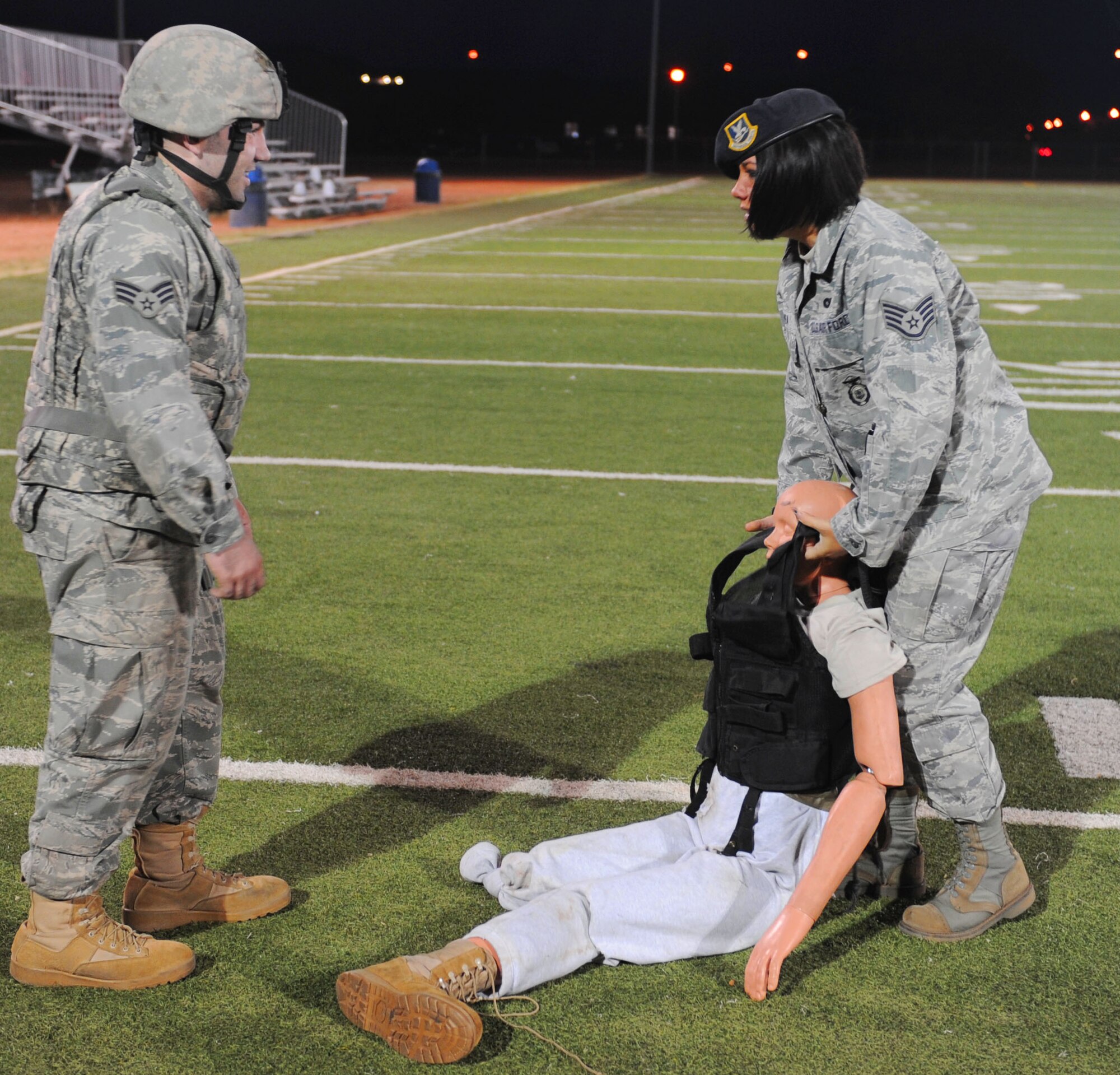 Staff Sgt. Jama Cohea, 7th Security Forces Squadron, demonstrates how to drag a dummy during the SFS 2011 Global Strike Challenge team tryouts, Sept.27, 2011, at Dyess Air Force Base, Texas. The tryouts consisted of a 40-yard shuffle carrying a 210-pound dummy and a half-mile run with full gear on. (U.S. Air Force photo by Airman 1st Class Cierra Bullock/Released)