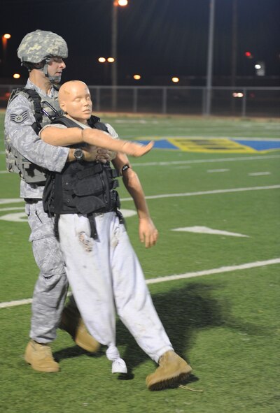 Staff Sgt. David Schwartz, 7th Security Forces Squadron, drags a 210-pound dummy across the football field during tryouts for the SFS 2011 Global Strike Challenge team, Sept. 27, 2011, at Dyess Air Force Base, Texas. The airmen selected will represent Dyess in the GSC at Barksdale Air Force Base, La. (U.S. Air Force photo by Airman 1st Class Cierra Bullock/Released)           