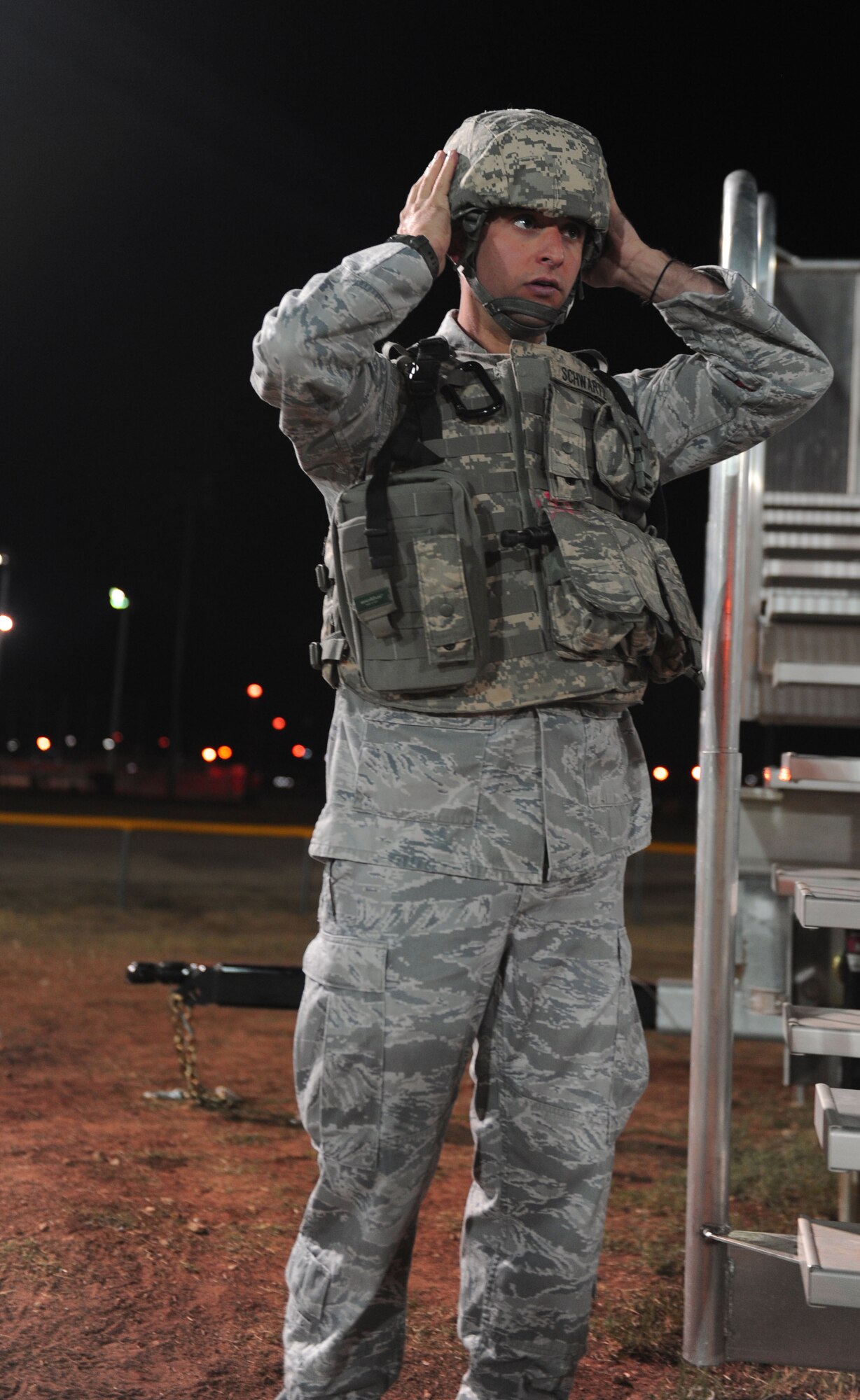 Staff Sgt. David Schwartz, 7th Security Forces Squadron, puts on protective gear as he gets ready to try out for the SFS 2011 Global Strike Challenge team, Sept. 27, 2011, at Dyess Air Force Base, Texas. The tryouts consisted of a 40-yard shuffle carrying a 210-pound dummy and a half-mile run with full gear on. (U.S. Air Force photo by Airman 1st Class Cierra Bullock/Released)      