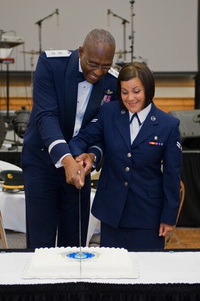 Maj. Gen. Harold Mitchell, Deputy Inspector General of the Air Force, and Airman 1st Class Jackelyn Lamboyvega, 341st Medical Operations Squadron mental health technician, cut a cake as the youngest and oldest members attending the Air Force Ball Sept. 17.  (U.S. Air Force photo/Beau Wade)