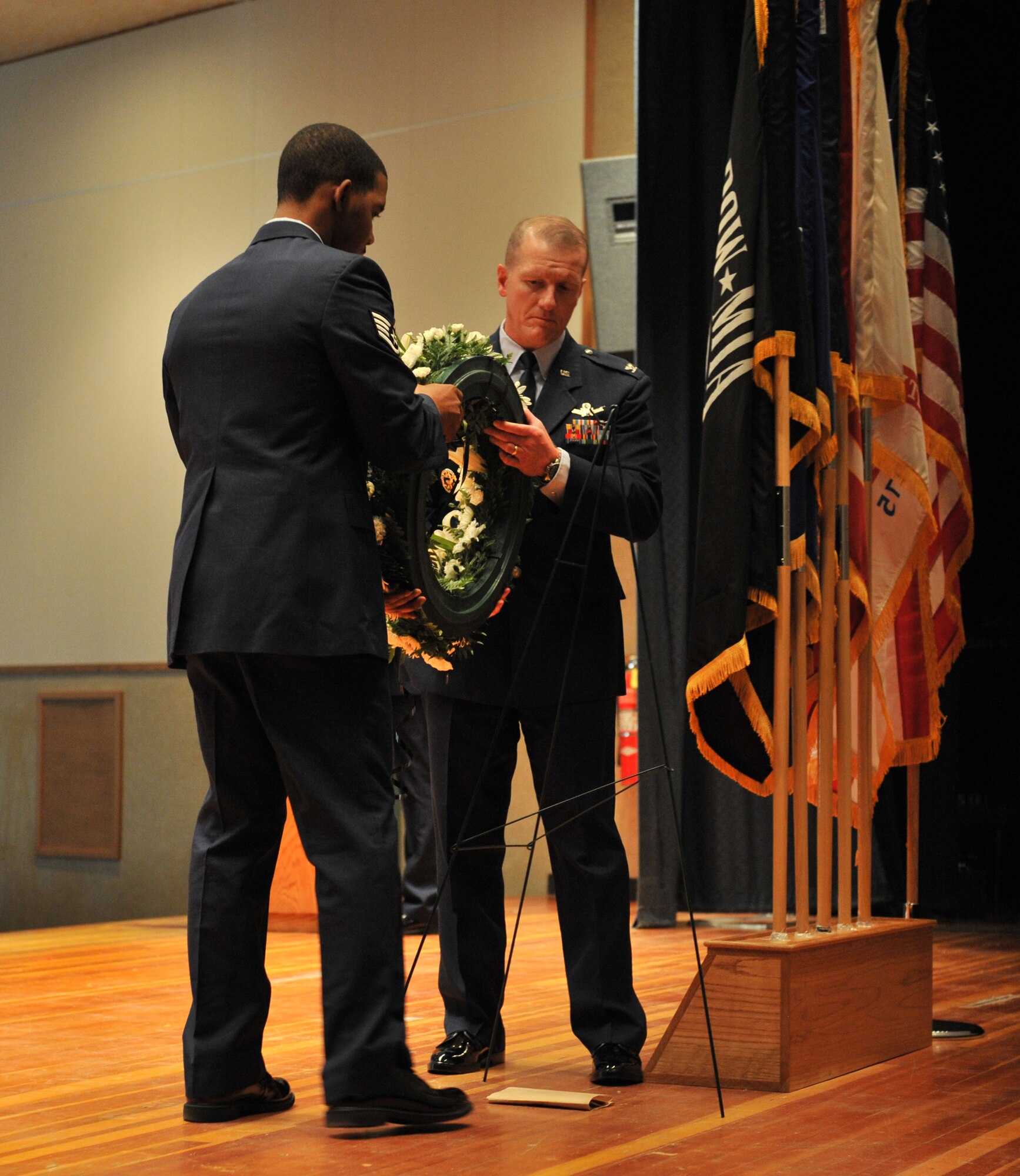 Col. Robert Stanley, 341st Missile Wing vice commander, and Staff Sgt. Sir Thomas, 341st Logistics Readiness Squadron traffic management, lay a wreath to honor all prisoners of war and the men and women missing in action during Malmstrom's POW/MIA ceremony held in the base auditorium Sept. 16.  (U.S. Air Force photo/John Turner)