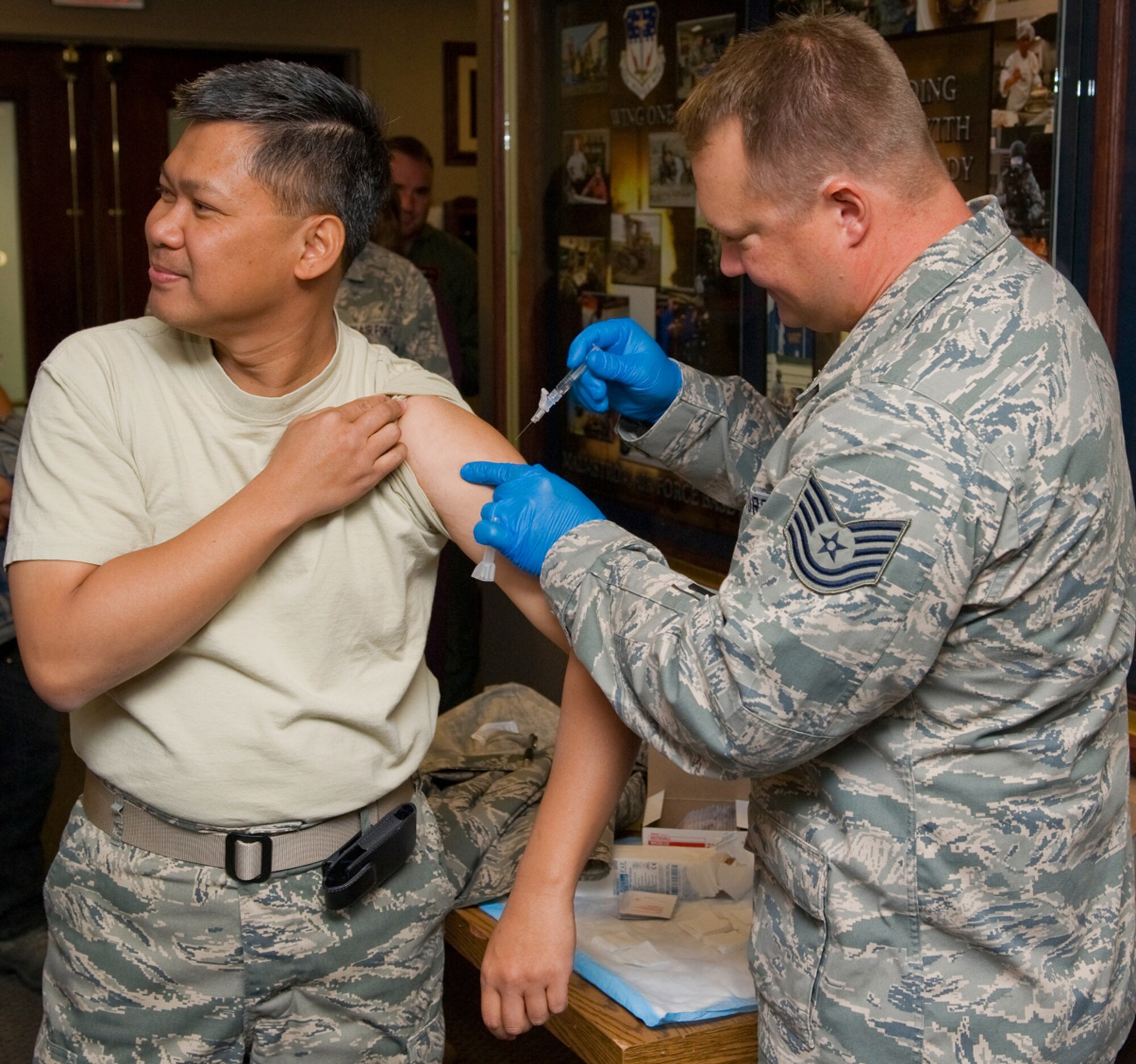 Tech. Sgt. Anthony Duranti, 341st Medical Operations Squadron immunizations technician, administers a flu shot to Col. Heraldo Brual, 341st Missile Wing commander, Sept. 21.  The Influenza vaccination will be available to all active-duty Airmen on base from Sept. 26-30 starting at 7:30 a.m. and ending at 4:30 p.m. every day in building 3080.  The flu vaccination will be available for dependants once all active-duty Airmen are vaccinated; tentatively starting Oct. 1. (U.S. Air Force photo/Beau Wade)