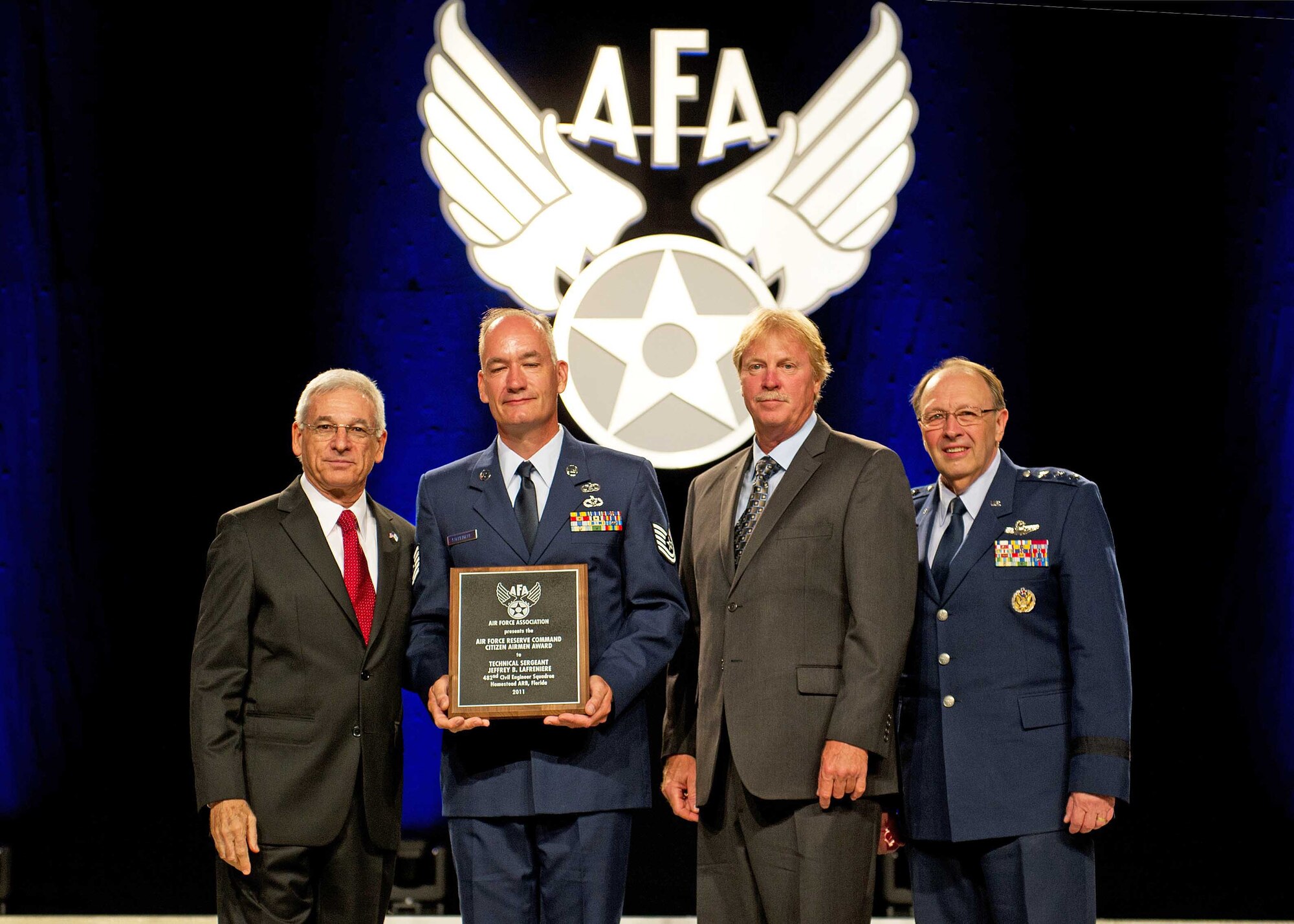 HOMESTEAD AIR RESERVE BASE, Fla. -- Tech. Sgt. Jeffrey Lafreniere, 482nd Civil Engineering Squadron and Mr. Kevin O'Shea from AT&T in Coral Springs, Fla., receiving the Air Force Association's Citizen Airman Award at the annual A.F.A. 2011 Air and Space Technology Exposition, Sep. 19. From Left to right: Sanford Schlitt, Chairman of the Board of the Air Force Association, Tech. Sgt. Jeffrey Lafreniere, 482nd CES, Mr. Kevin O'Shea manager, AT&T in Coral Springs, Fla., Lt. Gen. Charles Stenner, Commander, Air Force Reserve Command. (photo courtesy of A.F.A.) 