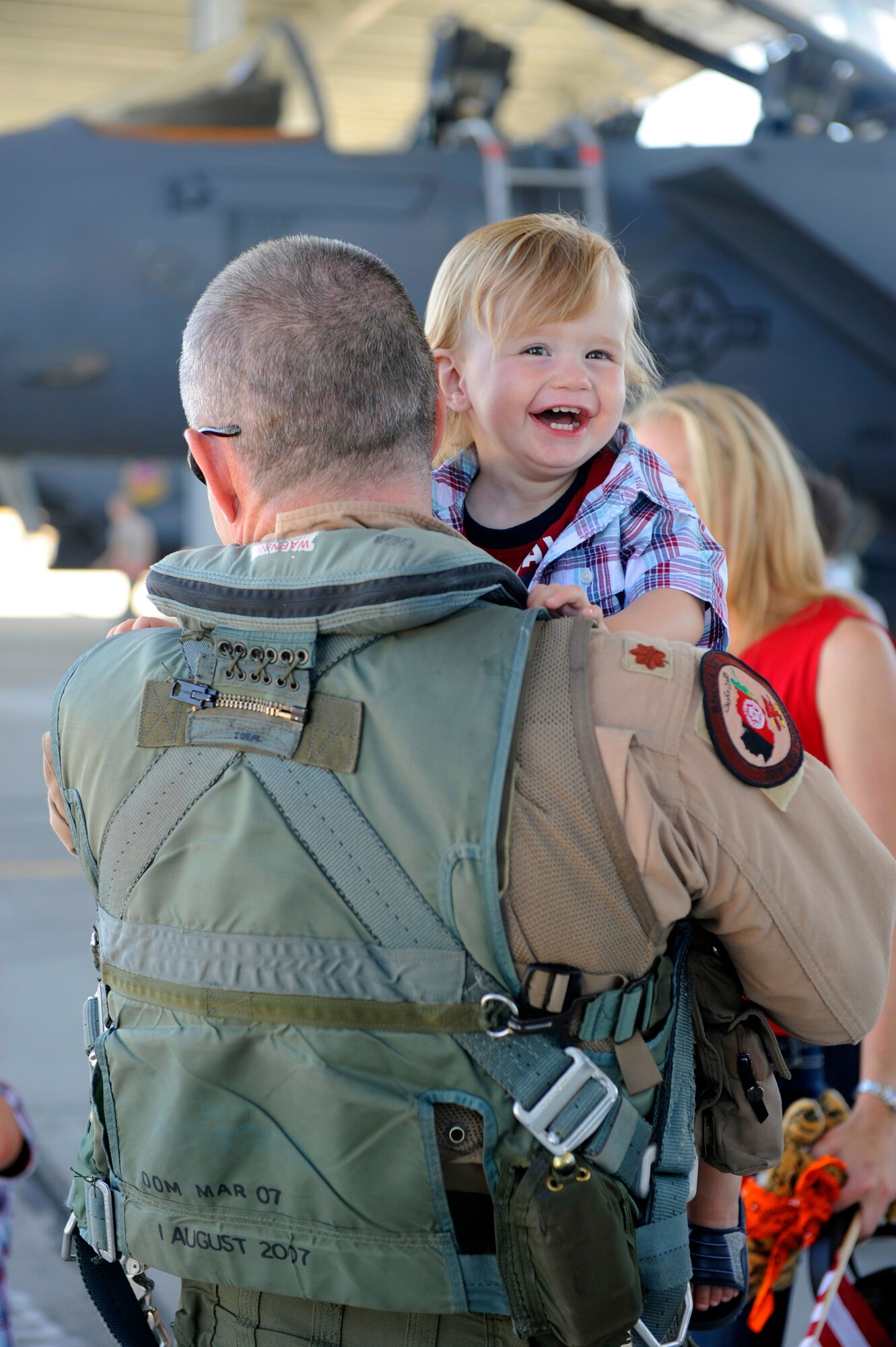 Mountain Home Air Force Base Gunfighter Maj. Sean Leaman, 389th Fighter Squadron, holds his youngest son Bryce for the first time in seven months Sept 26. Maj. Leaman is an F-15E Strike Eagle pilot who was part of the 389th FS deployment to Afghanistan where he personally flew over 100 combat missions. (U.S. Air Force photo by Senior Airman Angelina Drake) 