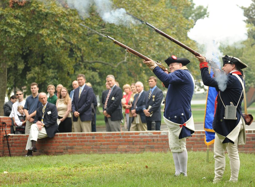 David Griffith and Jeffrey Brown, compatriots of the Sons of the American Revolution Virginia Society, perform a musket salute with revolutionary war era rifles during a grave marking ceremony at Langley Air Force Base, Va., Sept. 24, 2011. The ceremony officially marked the gravesite of Revolutionary War citizen patriot George Booker, who built his home on the site of the modern-day Langley Club. (U.S. Air Force photo by Airman 1st Class Teresa Cleveland/Released)