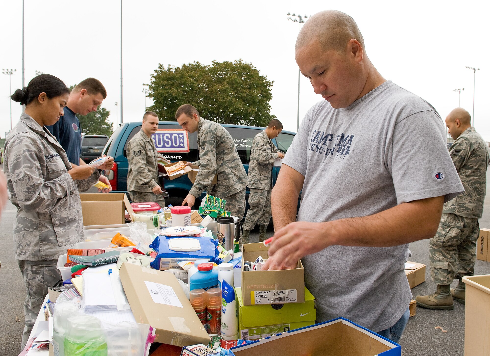 Members of Detachment 3, 373rd Training Squadron, assist USO Delaware personnel assort recent donations at Dover Air Force Base, Del., on Sept. 26, 2011. The donations will be stored in a warehouse until needed by service members.  (U.S. Air Force photo by Roland Balik)