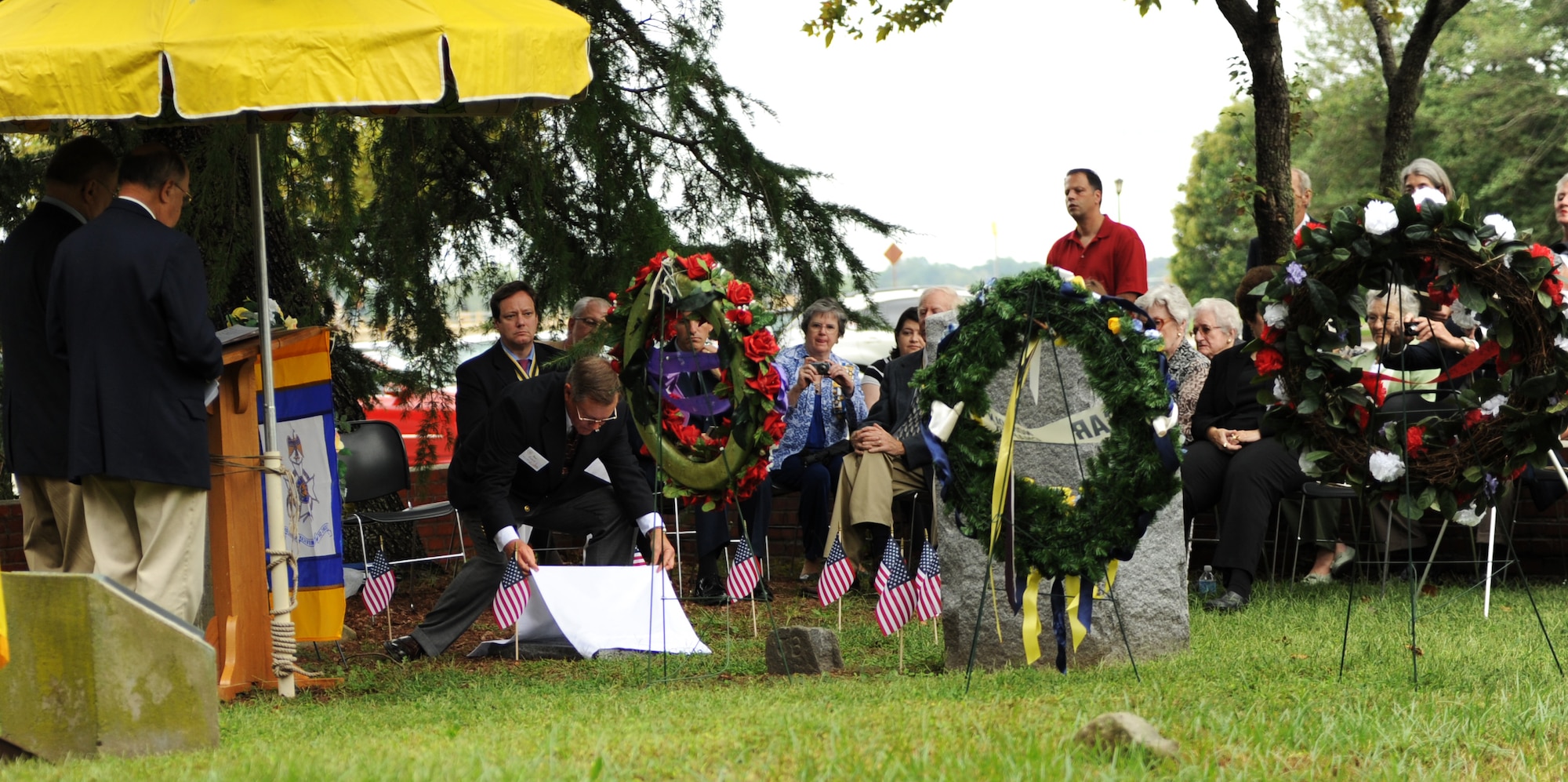 Samuel Endicott, member of the Sons of the American Revolution Virginia Society, unveils the grave marker for George Booker at Langley Air Force Base, Va., Sept. 24, 2011. The grave marking ceremony was held to honor Booker, Revolutionary War citizen patriot and a member of the House of Delegates from 1782-1804. (U.S. Air Force photo by Airman 1st Class Teresa Cleveland/Released)