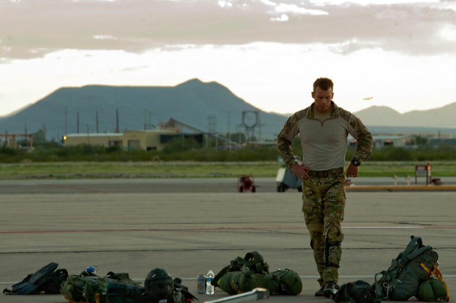 Master Sgt. Todd Popovic, a pararescueman with the 48th Rescue Squadron, goes over his equipment prior to a night training mission at Davis-Monthan Air Force base, Az. on Sept. 23, 2011. Popovic and members of the 48th RQS train with fellow rescue units, the 55th and 79th Rescue Squadron's, on a regular basis in order to prepare them for their real-world missions., which (U.S. Air Force photo by Staff Sgt. Joshua J. Garcia/Released)