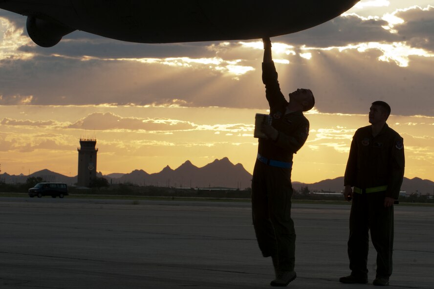 U.S. Air Force Staff Sergeants Thomas Sinon and Chris Bageant, 79th Rescue Squadron flight engineers, pre-flight the refueling pod on a HC-130P Combat King prior to a training mission at Davis-Monthan Air Force Base, Az. on Sept. 23, 2011. The refueling pod houses the hose used to refuel fellow aircraft while in flight. (U.S. Air Force photo by Staff Sgt. Joshua J. Garcia/Released)