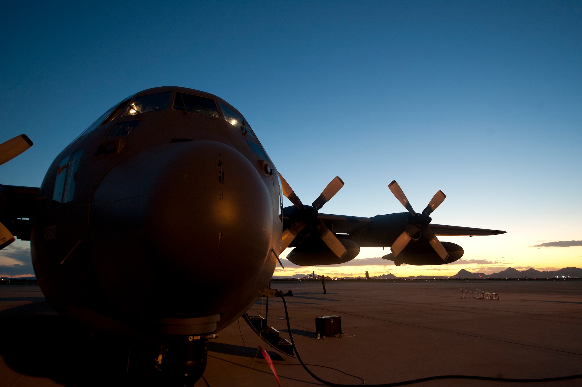 A HC-130P Combat King from the 79th Rescue Squadron, sits on the flight-line at Davis-Monthan Air Force Base, Az., as pre-flight procedures are being done prior to a night mission on Sept. 23, 2011. The Combat King is the only fixed wing aircraft in the U.S. Air Force's inventory that is used for personnel recovery. U.S. Air Force photo by Staff Sgt. Joshua J. Garcia/Released)