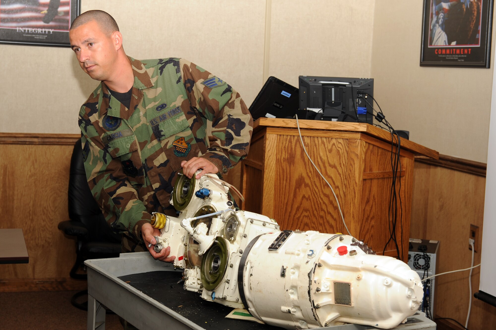 Senior Airman Hugo Garcia, 372nd Training Squadron instructor, displays an airframe mounted accessories drive to students during a classroom session at Seymour Johnson Air Force Base, Sept. 23, 2011. The airframe mounted accessories drive is one of the key starting systems for an aircraft. The 372nd training squadron is a detachment from Sheppard Air Force Base, Texas, and is a secondary technical training location for Airmen who will work on F-15s at their first duty station. Garcia is a native of Parlier, Calif. (U.S. Air Force photo by Senior Airman Whitney Lambert)
