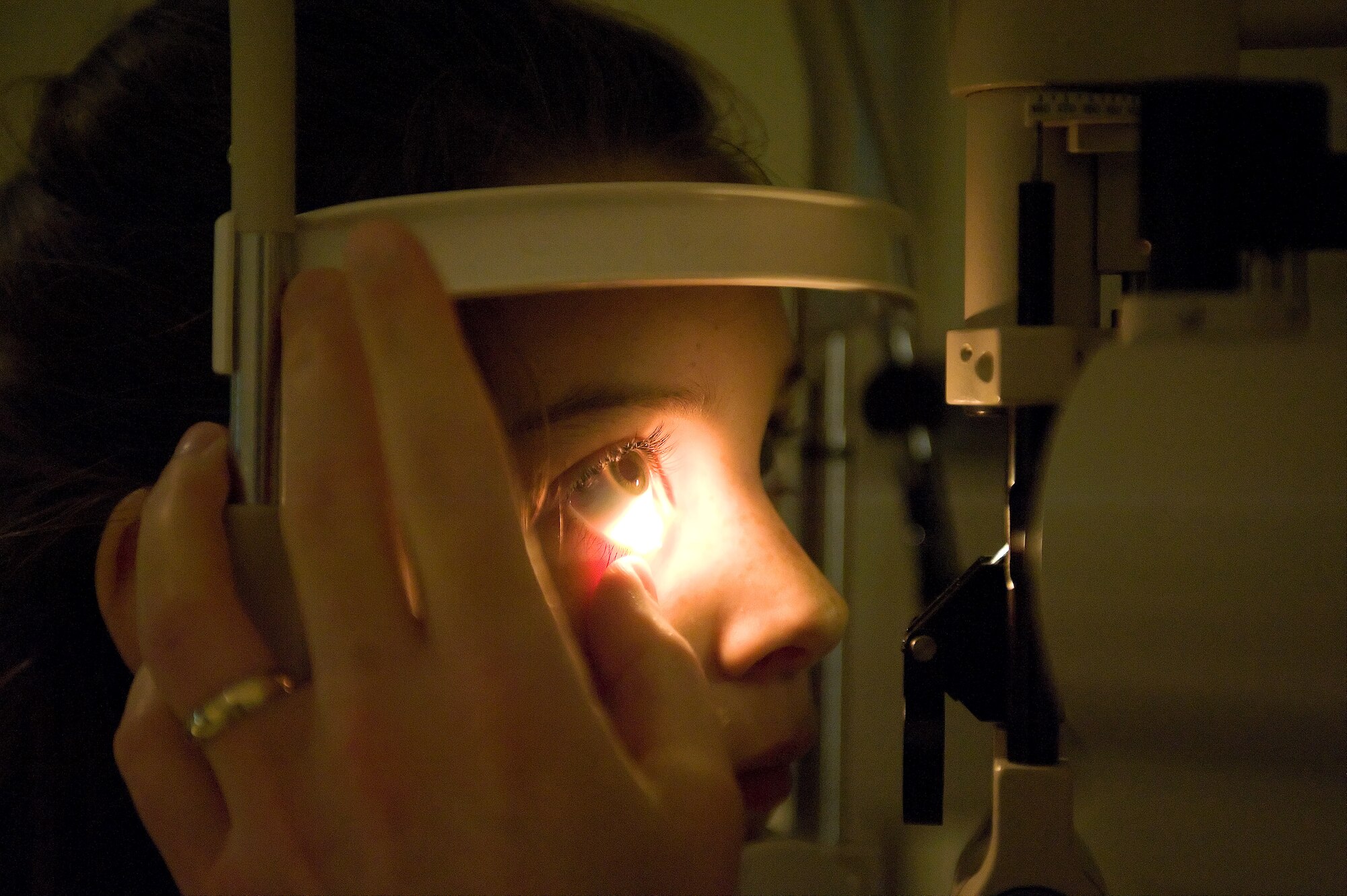 Emma Lusignan gets her eye examined by Maj. (Dr.) Jeffrey Newsom, the optometry flight commander for the 436th Aerospace Medicine Squadron, Sept. 26, 2011, at Dover Air Force Base, Del. The Dover AFB Optometry Clinic is ranked number one in Air Mobility Command and number two in the Air Force. (U.S. Air Force photo by Steve Kotecki)