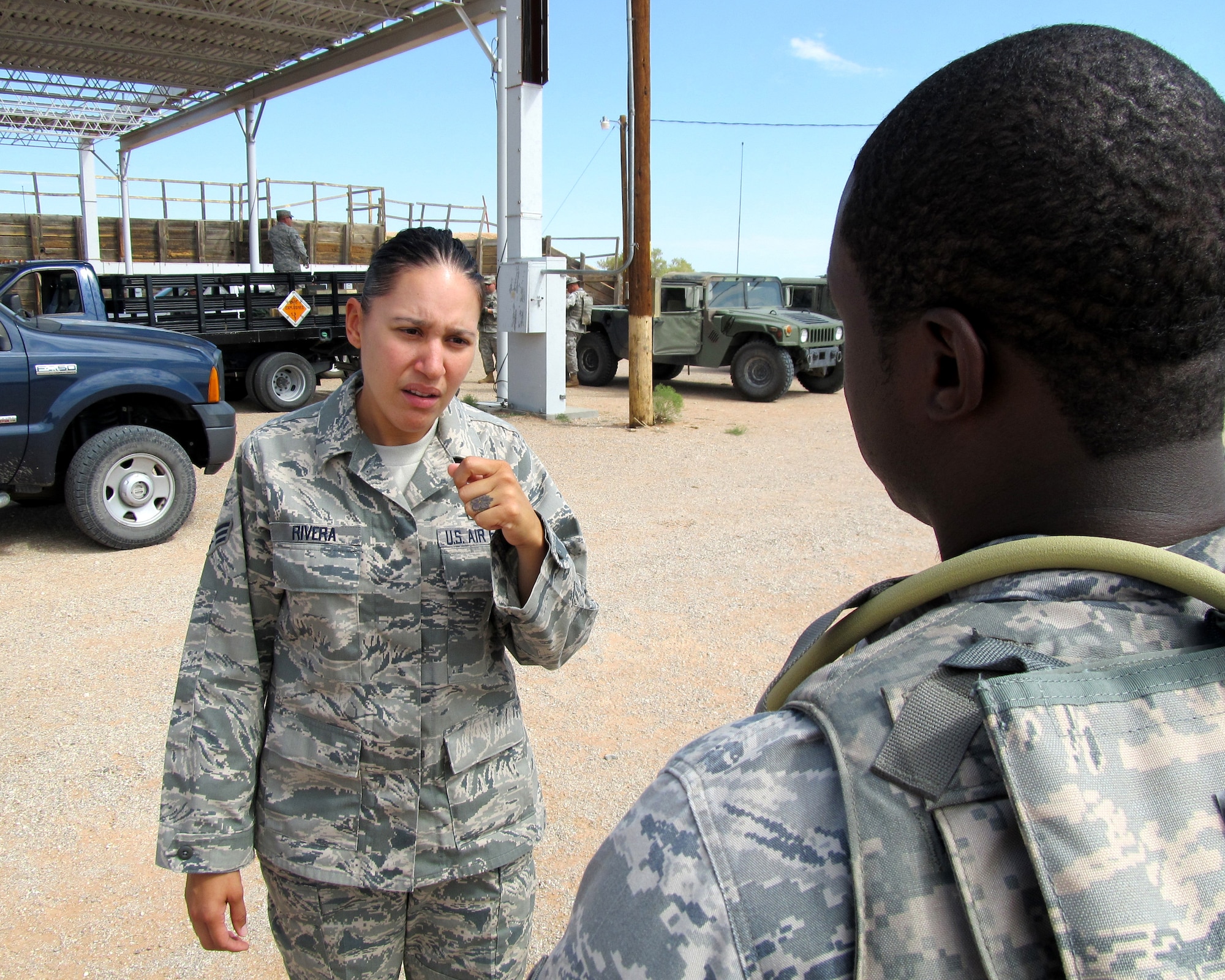 Senior Airman (SrA) Luz Rivera, an aerospace medical technician with the Texas Air National Guard?s 149th Fighter Wing at Lackland Air Force Base, Texas, visits with a student before training operations begin at the Texas Air National Guard?s 204th Security Forces Squadron at Fort Bliss, Texas; Sept. 13, 2011. (Air National Guard photo by Staff Sgt. Phil Fountain/Released)