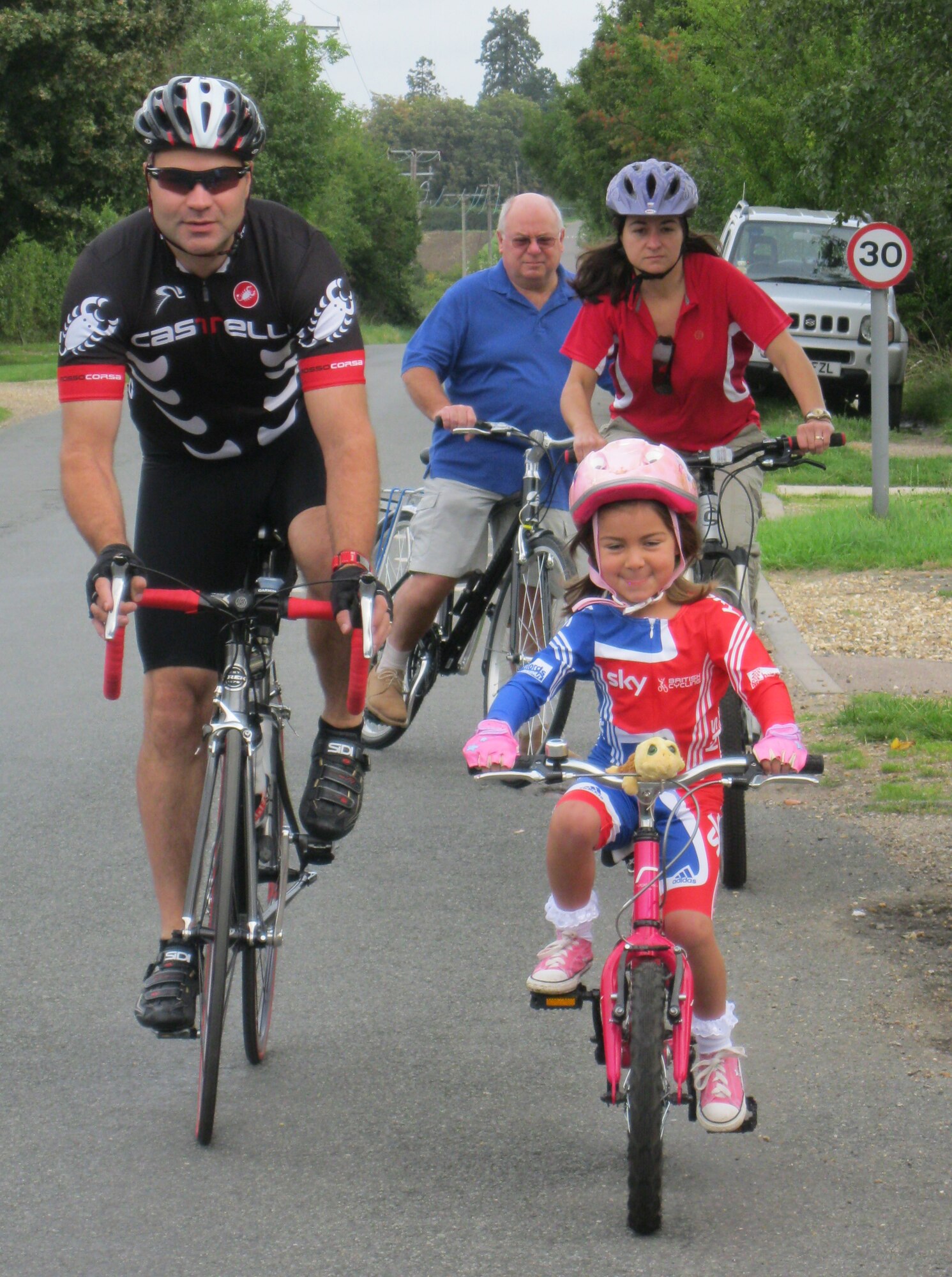 CHEVINGTON, England – (left to right) Tech. Sgt. Chad Cox, 748th Aircraft Maintenance Squadron resource advisor, rides with father-in-law, Michael Wilde, wife Catherine and 5-year-old daughter Anika during the Suffolk Historic Churches bike event, Sept. 10, 2011. Cox hopes to participate in the London to Paris bike event July 2012. (Courtesy photo by Valerie Wilde)