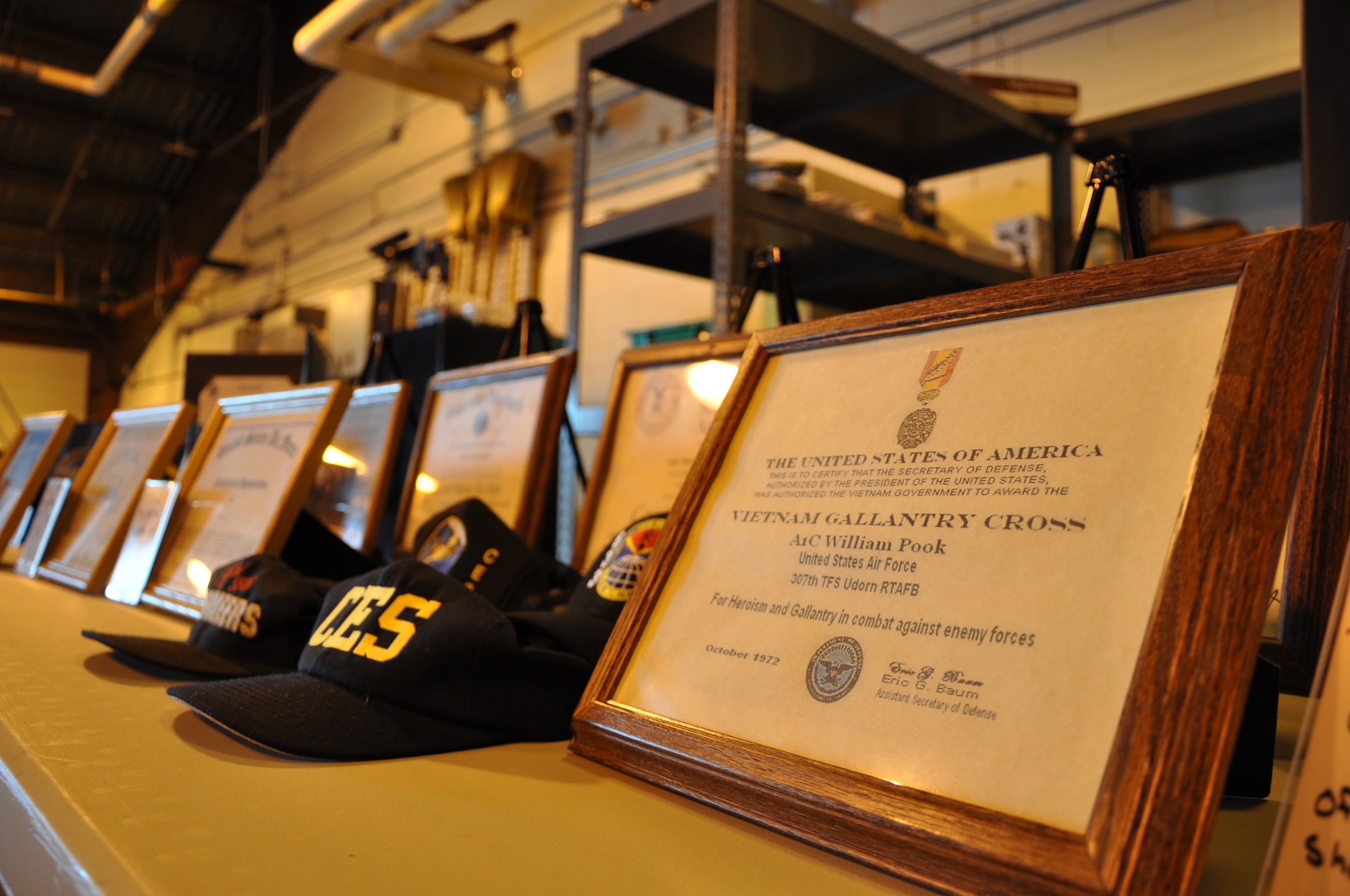 Citations, photographs and other relics belonging to Master Sgt. William Pook, a reservist assigned to the 633rd Civil Engineer Squadron, are displayed during his retirement ceremony at the squadron’s Emergency Management flight warehouse at Langley Air Force Base, Va., Sept. 23, 2011. Pook, one of a handful of Vietnam veteran’s still serving, retired after 40 years in the Air Force. (U.S. Air Force photo by Senior Airman Jason J. Brown/Released)