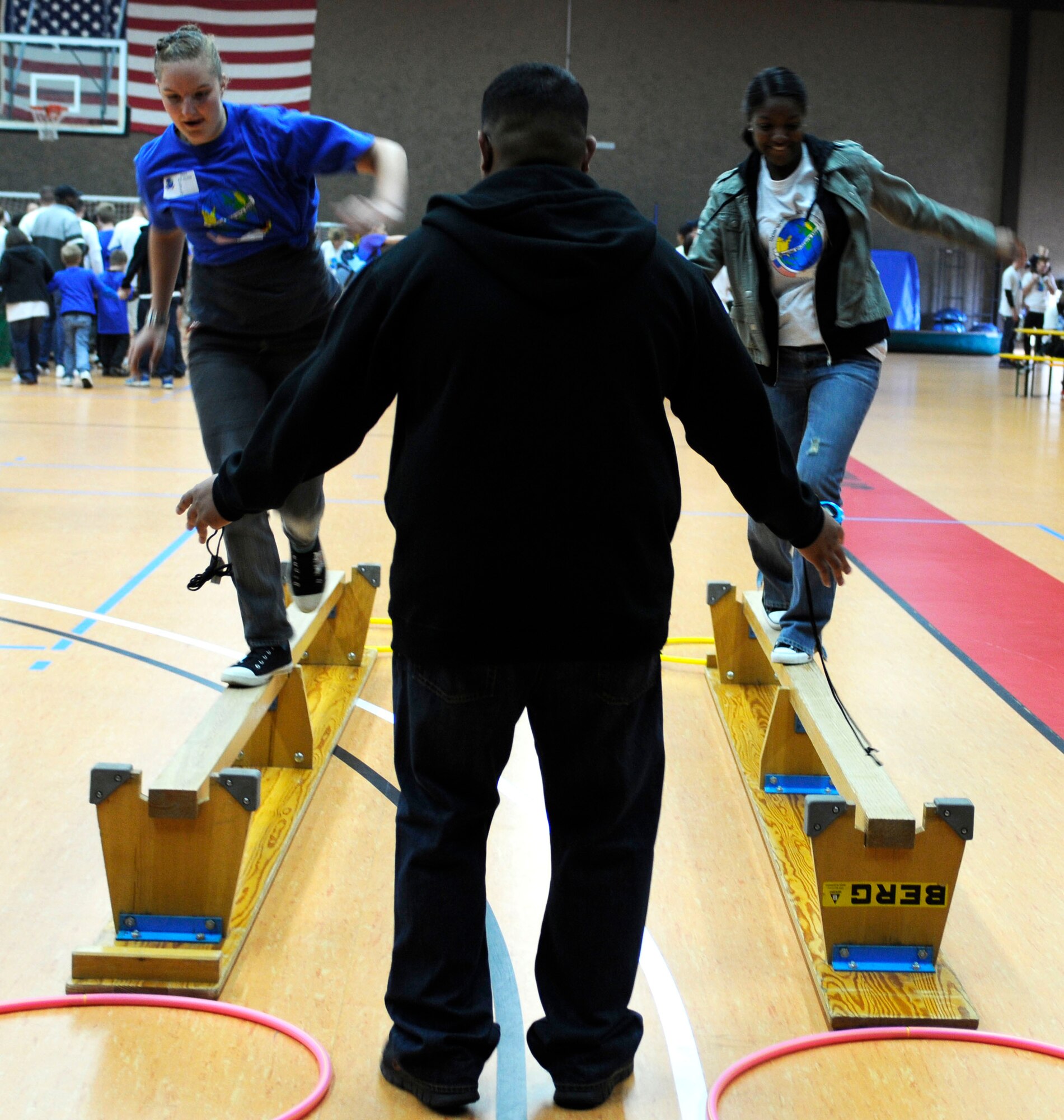 SPANGDAHLEM AIR BASE, Germany  --  Staff Sgt. Arman Aranda,52nd Aircraft Maintenance Squadron, right,   races her buddy, Eve Ernst, on a balance beam during St. Martin’s Special Children’s Day here  Sept. 22 at the Skelton Memorial Fitness Center. Airmen partnered up with children from Bitburg’s St. Martin’s School for a day of activities hosted by the air base. Airmen also volunteered to run the activities as children and their buddies went through them. This is the 16th year Spangdahlem AB has hosted the German and American partnership building event with the Bitburg school. (U.S. Air Force photo/Senior Airman Natasha E. Stannard)