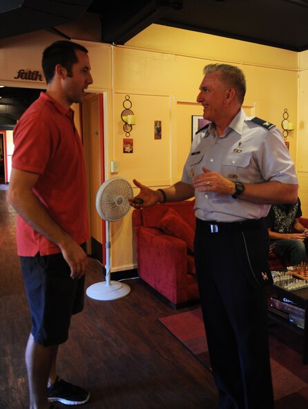 Col. Gregory Tate, Air Combat Command chaplain, coins Lance Houston, coordinator for the Soul Fire Café for outstanding service and leadership at the café, Sept. 24, 2011, at Dyess Air Force Base, Texas. The Soul Fire Café, headed by Houston, is a popular place where Airmen go to have fun in a friendly and hospitable environment. (U.S. Air Force photo by Airman 1st Class Cierra Bullock/Released)