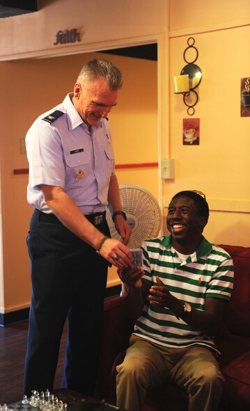 Col. Gregory Tate, Air Combat Command chaplain, assists an Airman during a game at the Soul Fire Café, Sept. 24, 2011, on Dyess Air Force, Texas. Col. Tate is visiting Dyess to meet with the ACC Chaplain Pastoral Staff, and will proceed to do Sunday services at the base chapel. (U.S. Air Force photo by Airman 1st Class Cierra Bullock/Released)