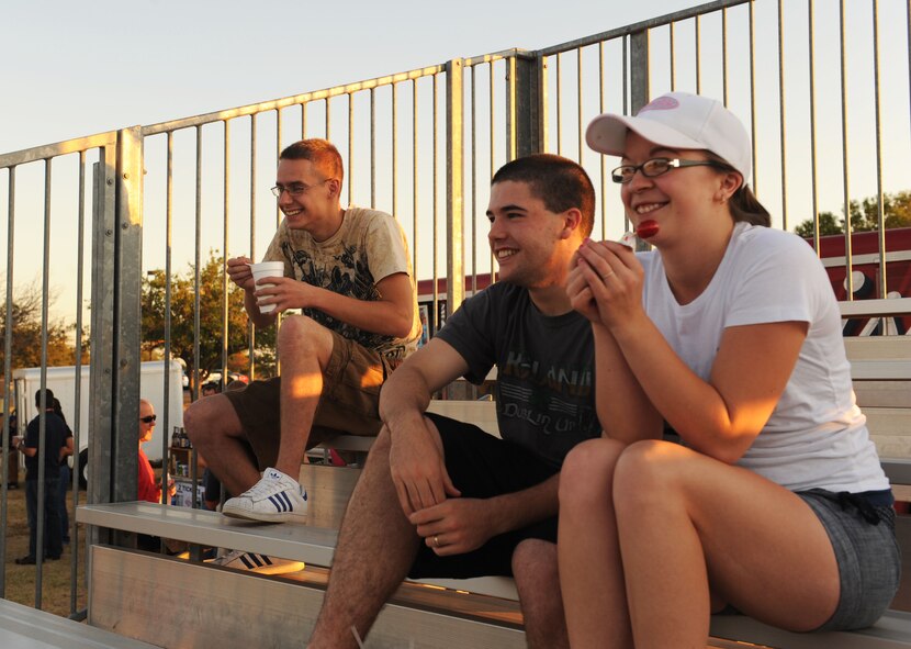 Dyess members and their families as well as retired military members wait for the show, Comedy Under the Stars to begin, Sept. 23, 2011, at Dyess Air Force Base Texas. The Comics on Duty World Tour has been performing for military members since 1992, both stateside and overseas and continues to bring family friendly entertainment to service members nationwide. (U.S. Air Force photo by Airman 1st Class Cierra Bullock/Released)
